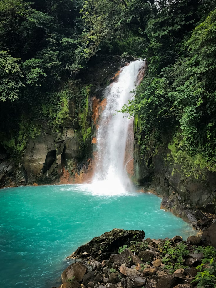 Oropendola Waterfall with turquoise pool in Costa Rica jungle