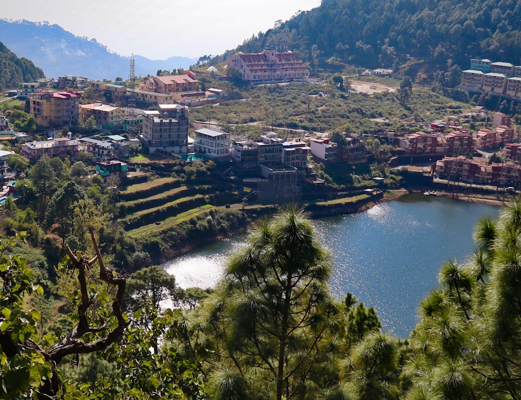Hillside town overlooking Naini Lake with terraced greenery