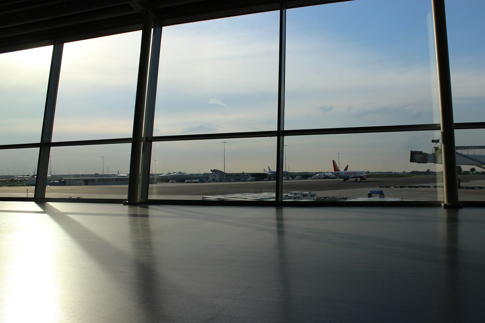 View of airport apron and aircraft from inside terminal
