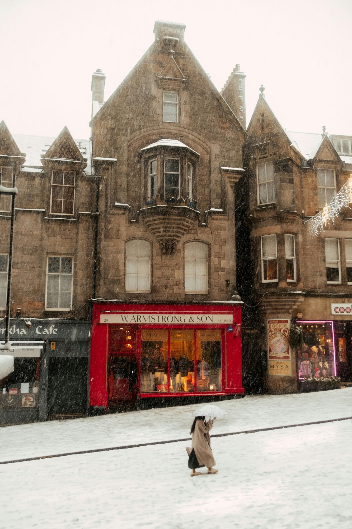 Snowy street scene in a Scottish city.