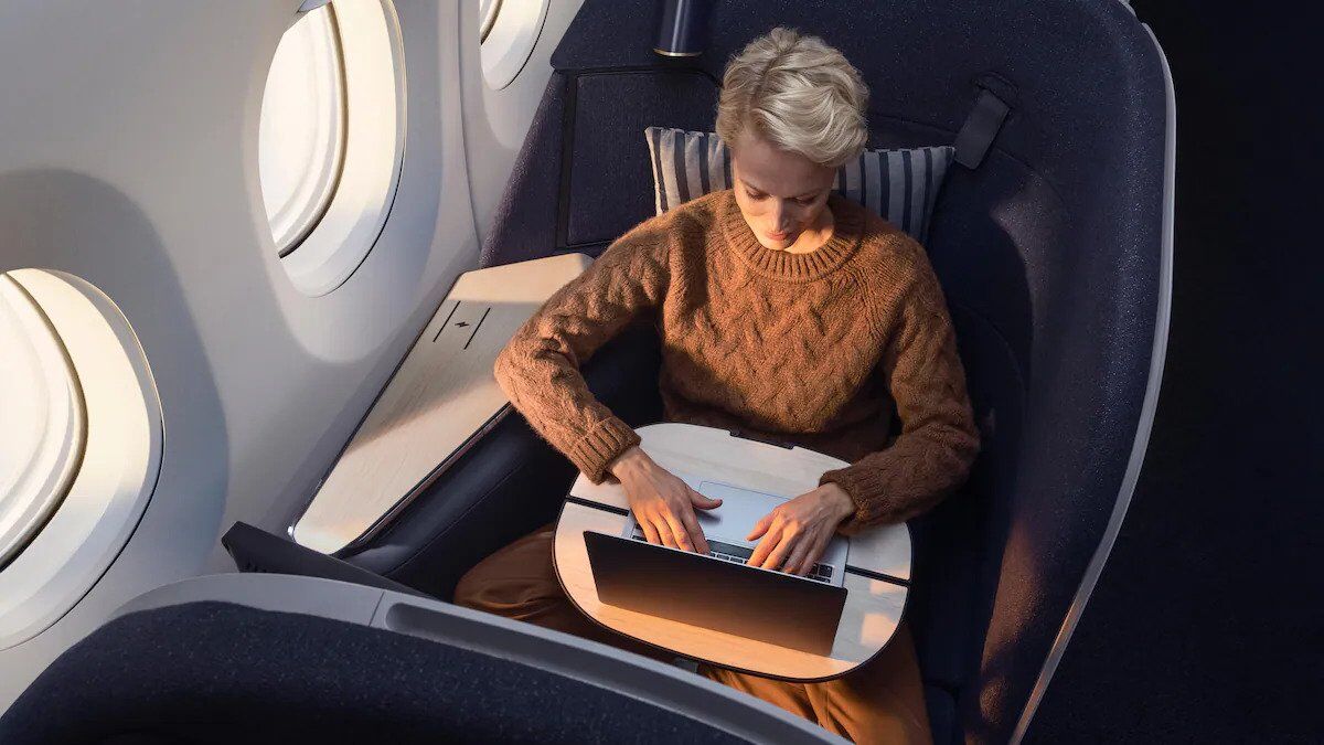 Passenger working on laptop in Finnair AirLounge business class seat