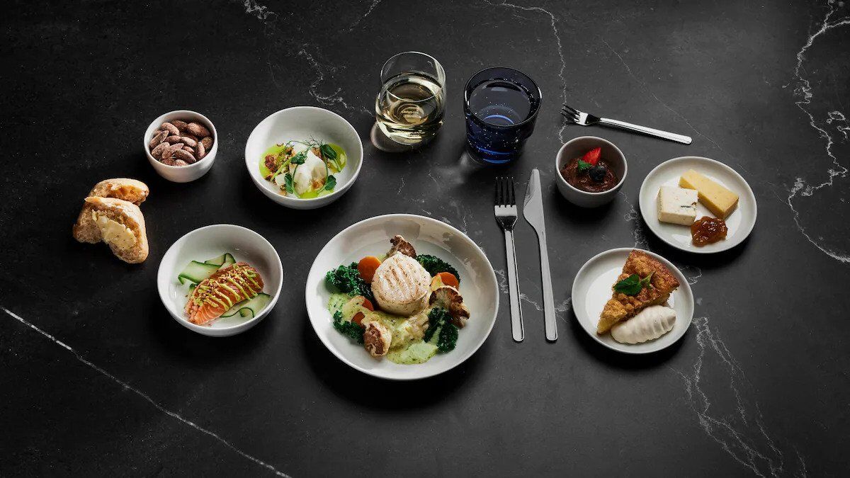 Finnair Business Class meal service on black tableware with multiple courses.
