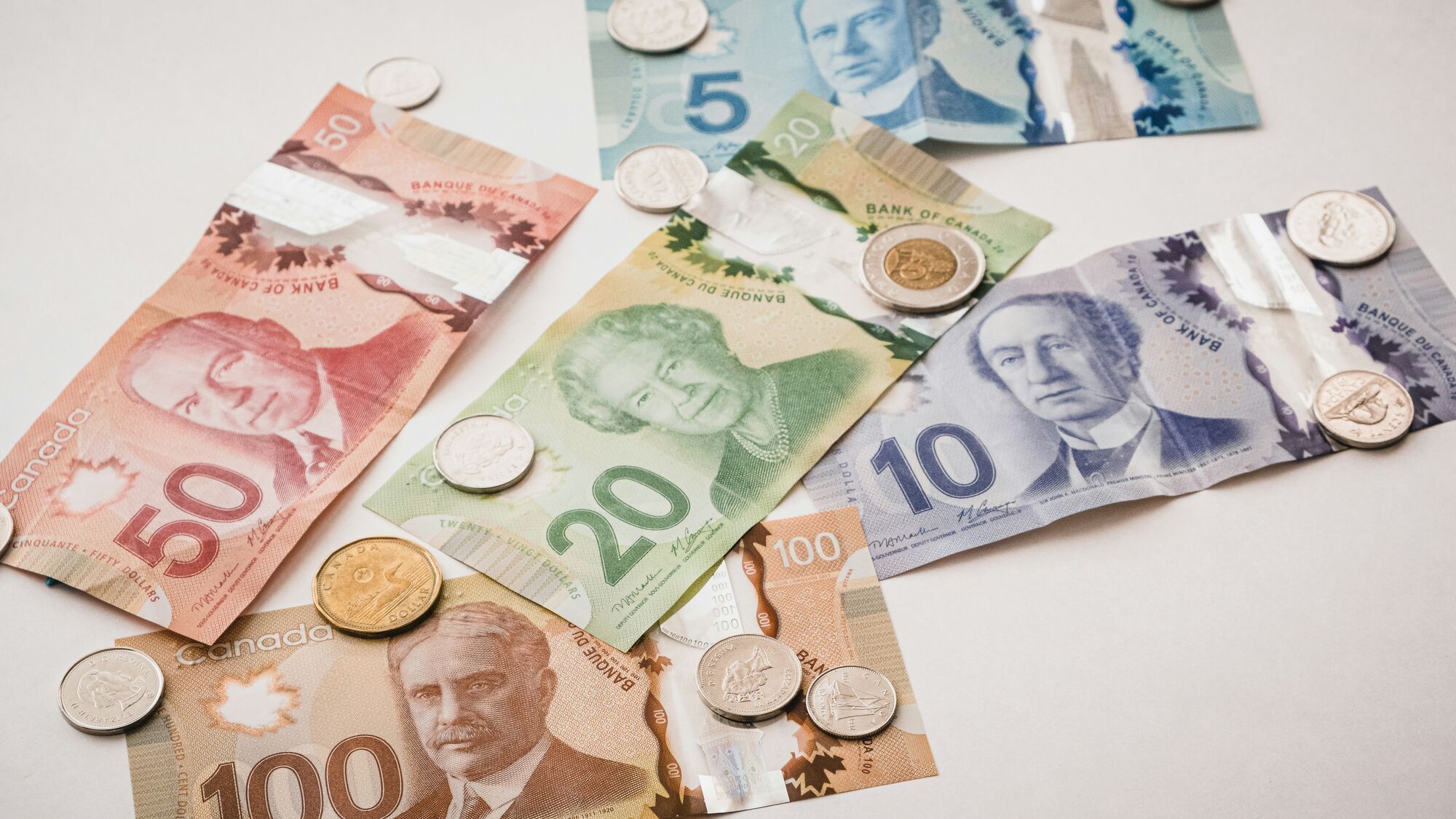 Spread of Canadian banknotes and coins on a table