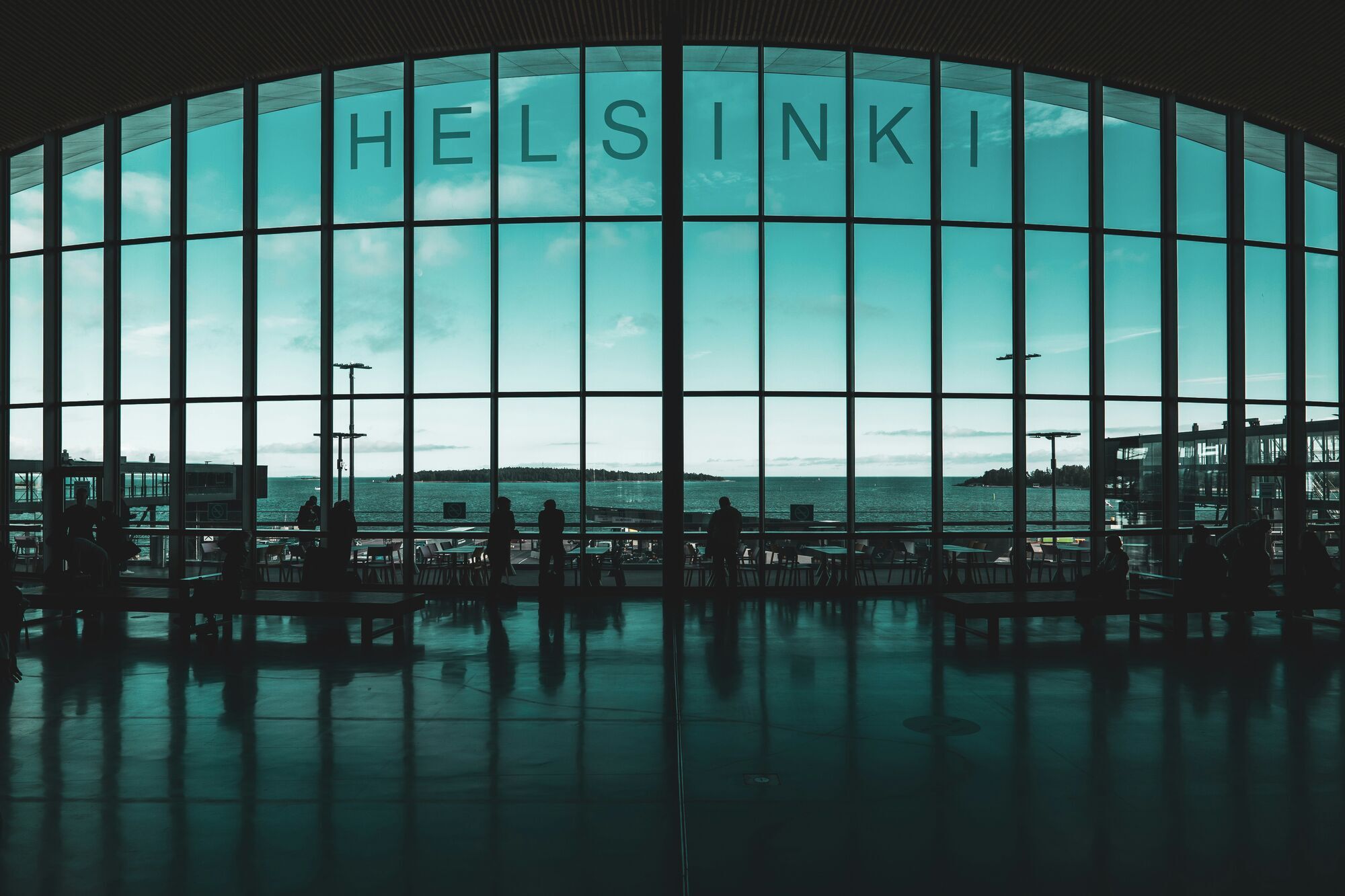 Interior of Helsinki Airport with large windows overlooking the sea