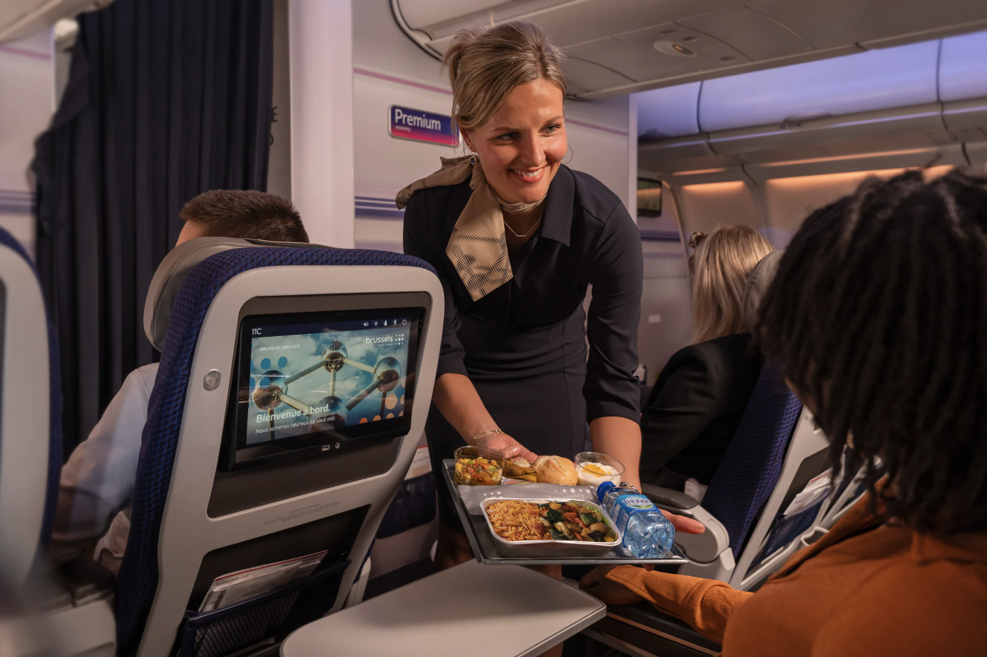 Brussels Airlines cabin crew serving inflight meal on long-haul flight