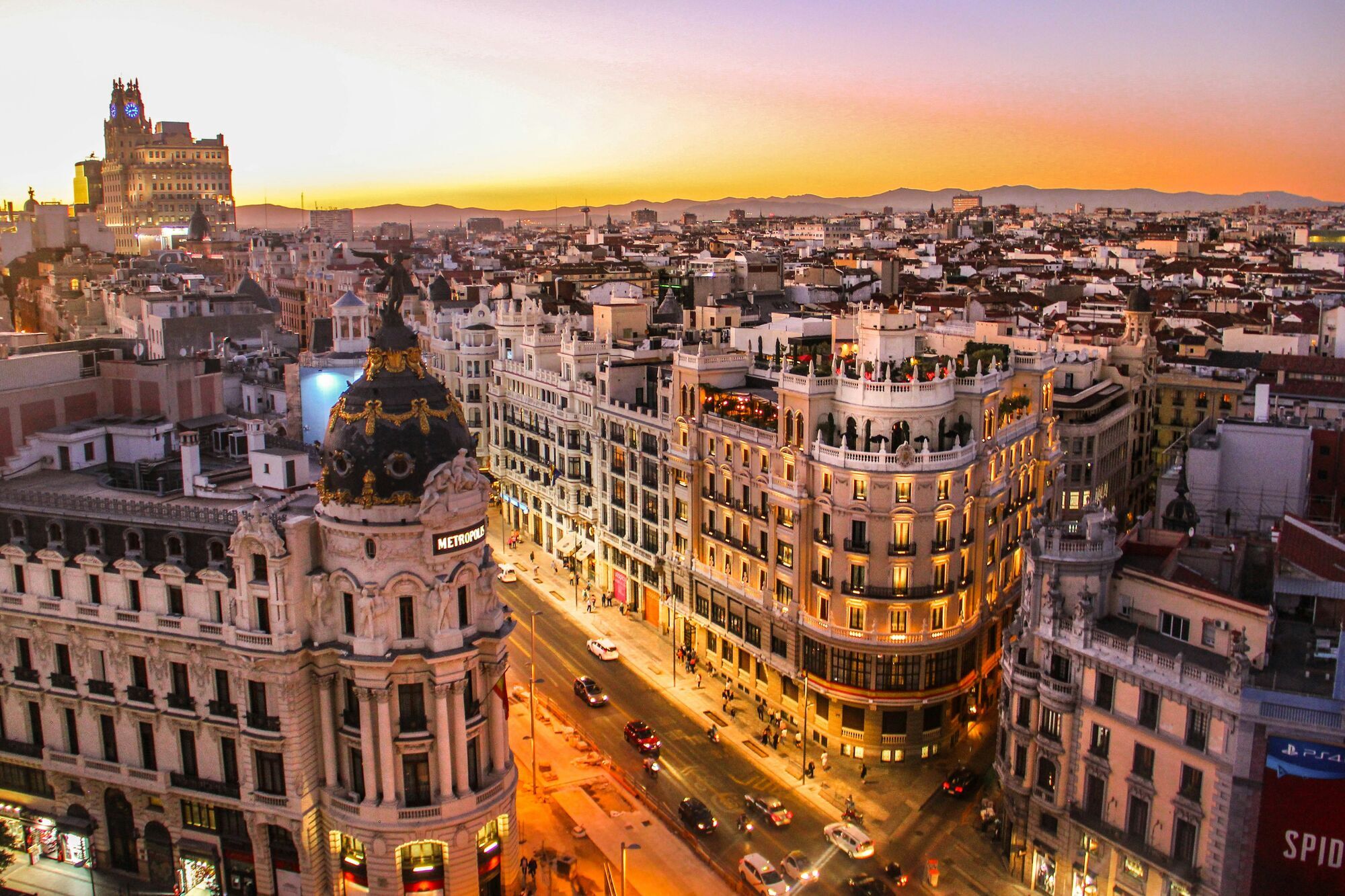 Sunset over Madrid’s Gran Vía with crowded streets