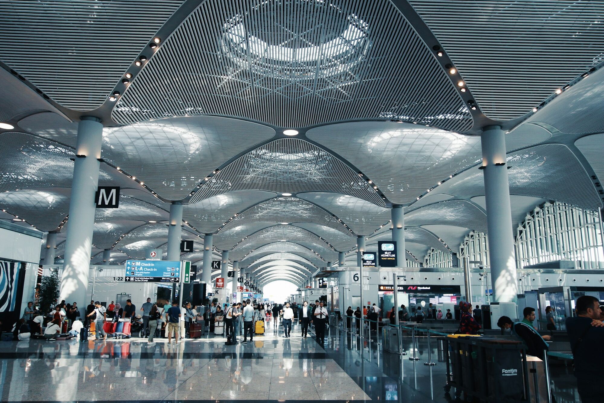 Passengers inside Istanbul Airport departures hall
