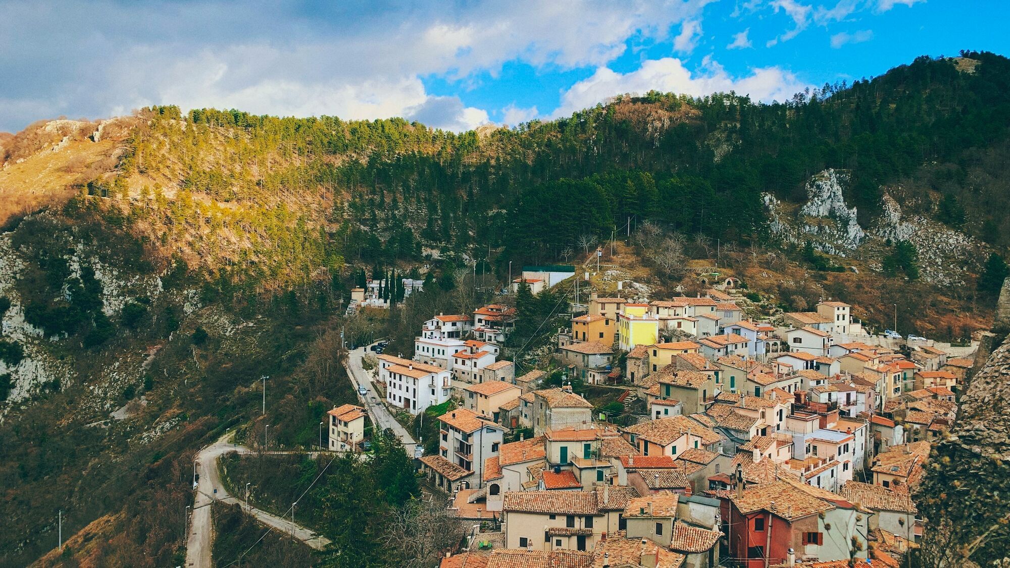 Hillside Italian town surrounded by forested mountains