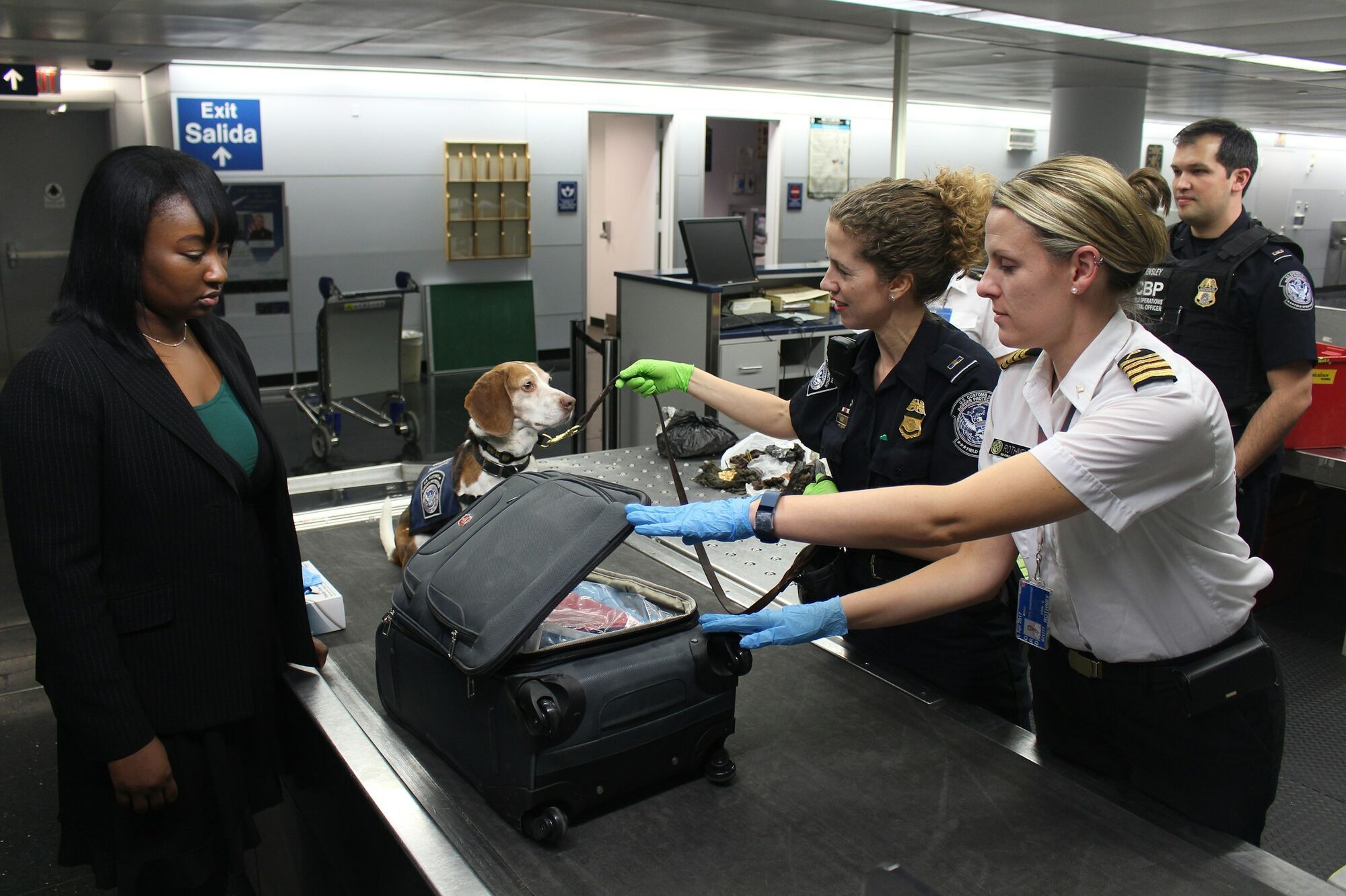 Airport staff inspect hand luggage during security checks