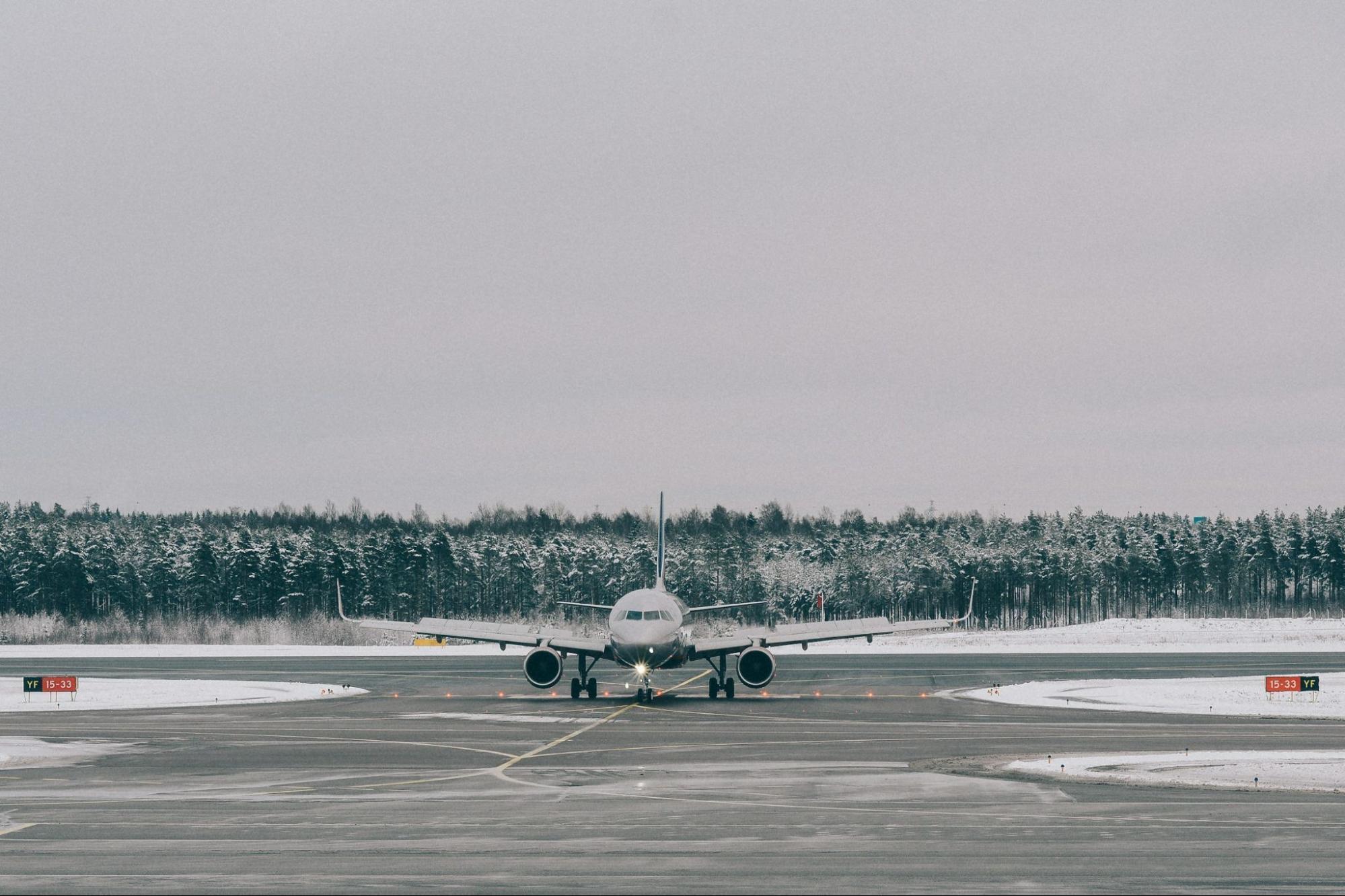 Aircraft taxiing on snow-covered runway
