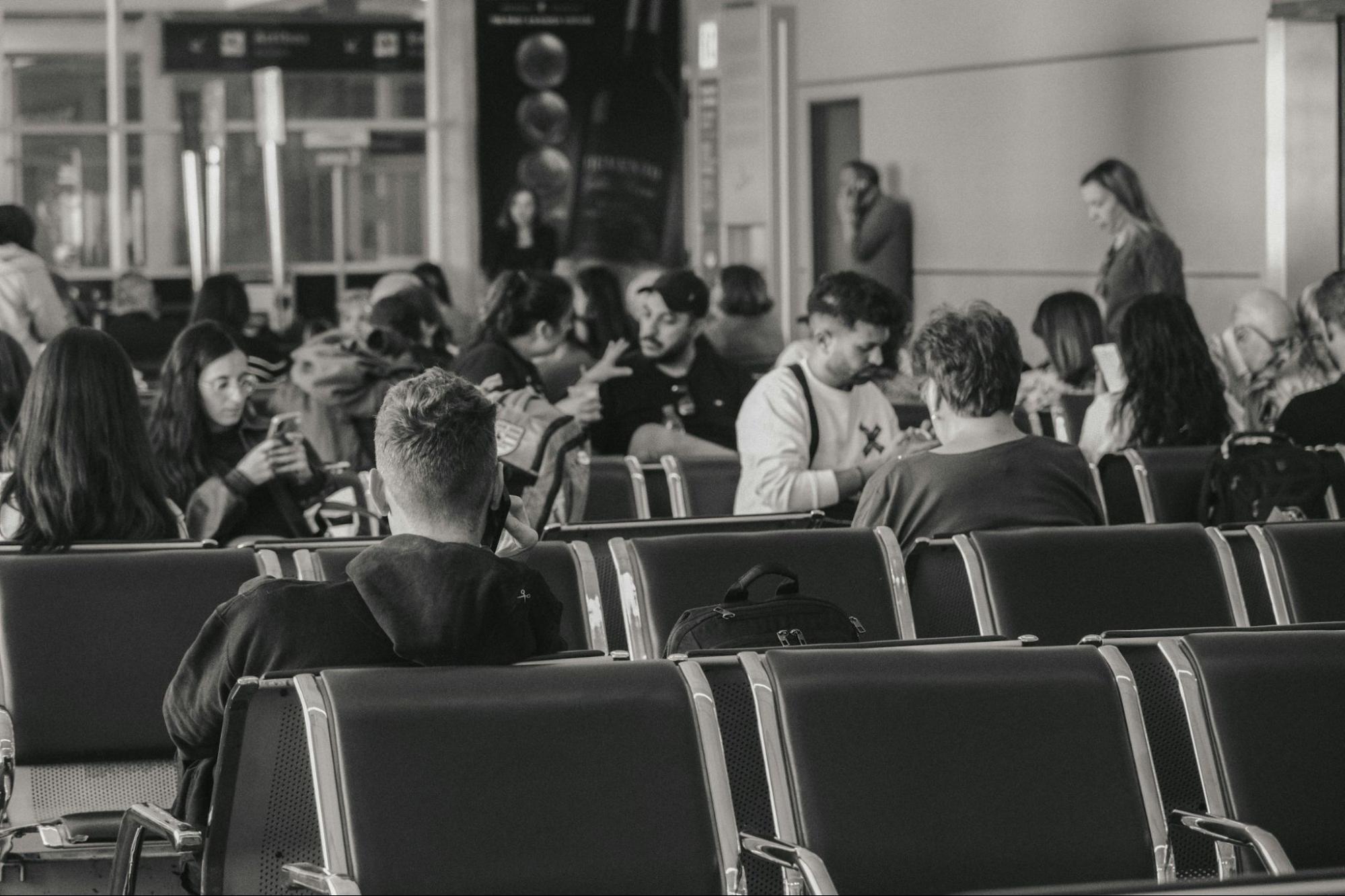 Passengers waiting in airport terminal during flight delays