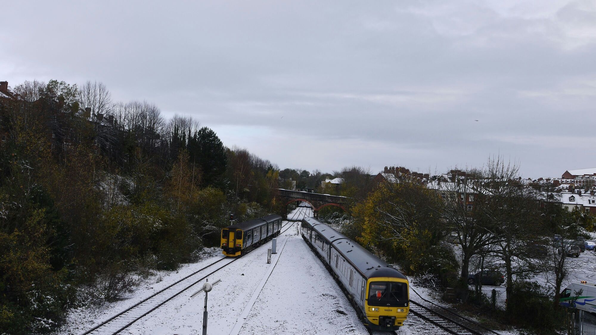 Two trains running on snow-covered railway tracks