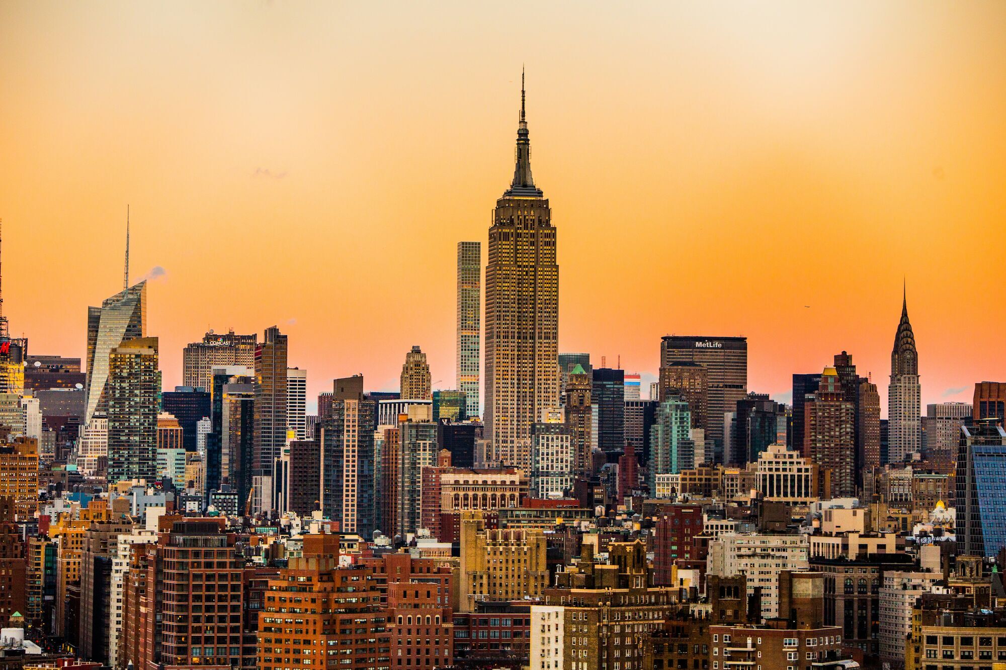View of Manhattan skyline with Empire State Building at sunset