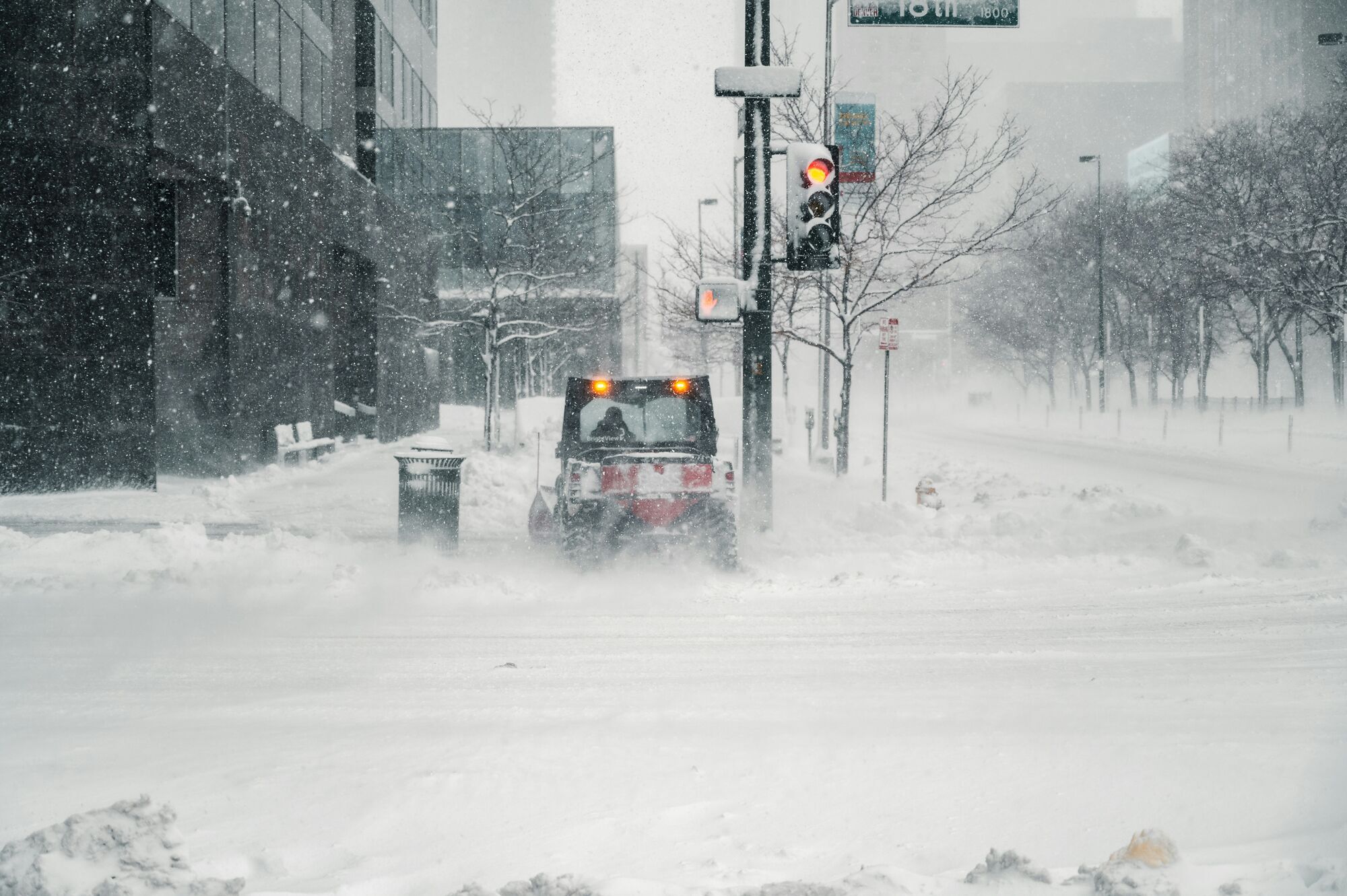 Snow-clearing vehicle working on a city street during a snowstorm