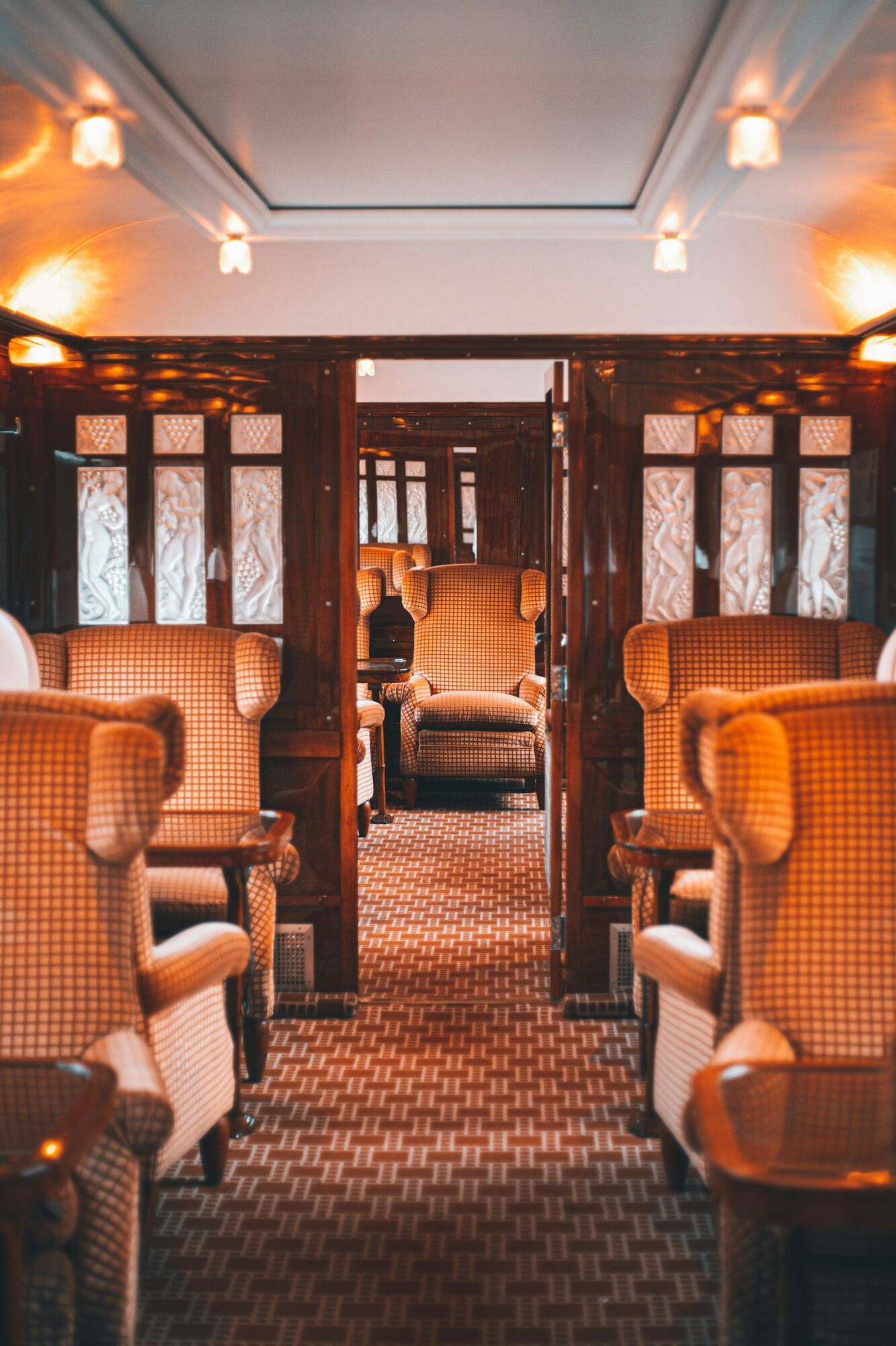 Vintage train lounge with armchairs and wood panelling