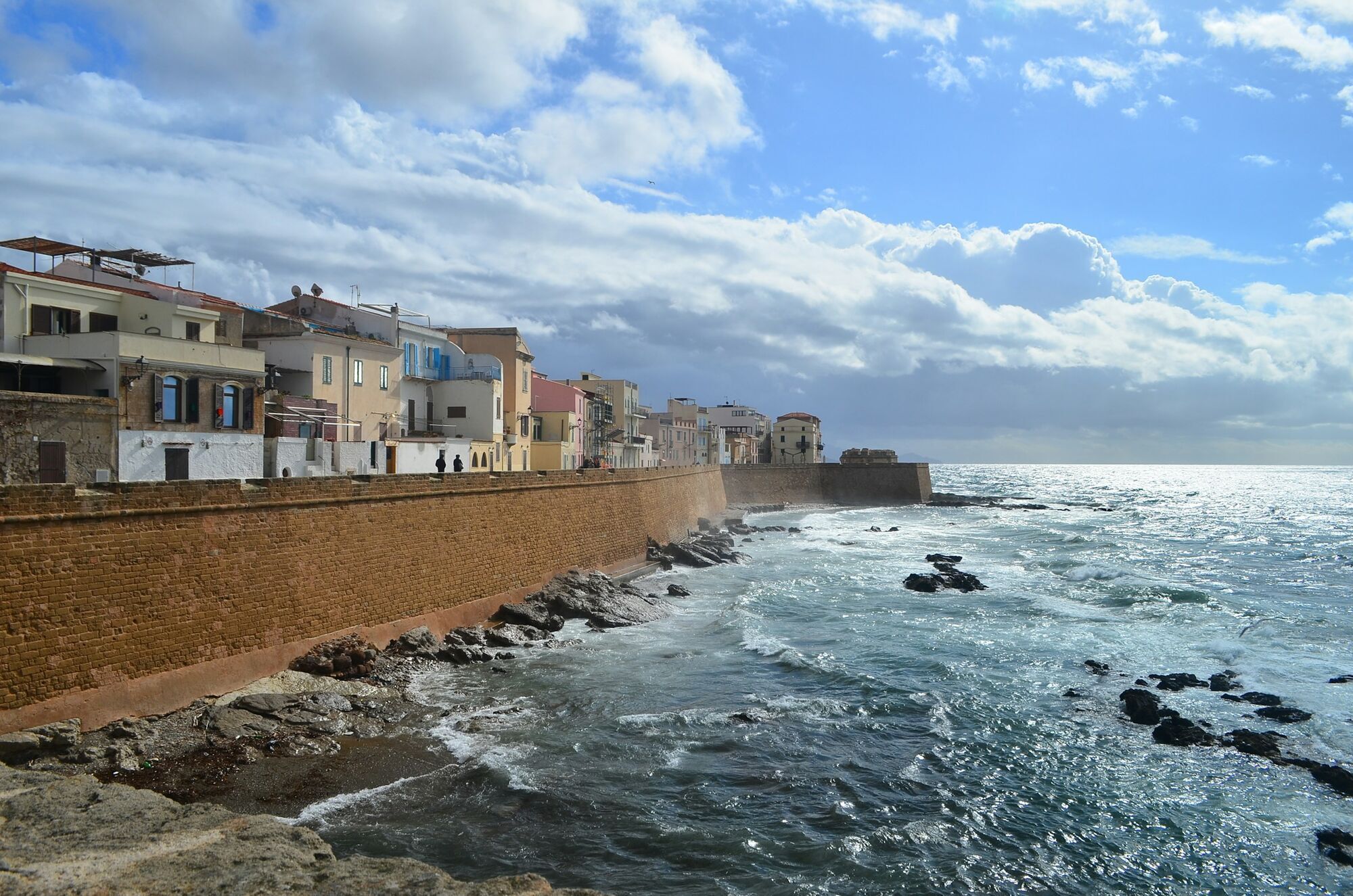 Historic waterfront buildings and sea walls in Alghero