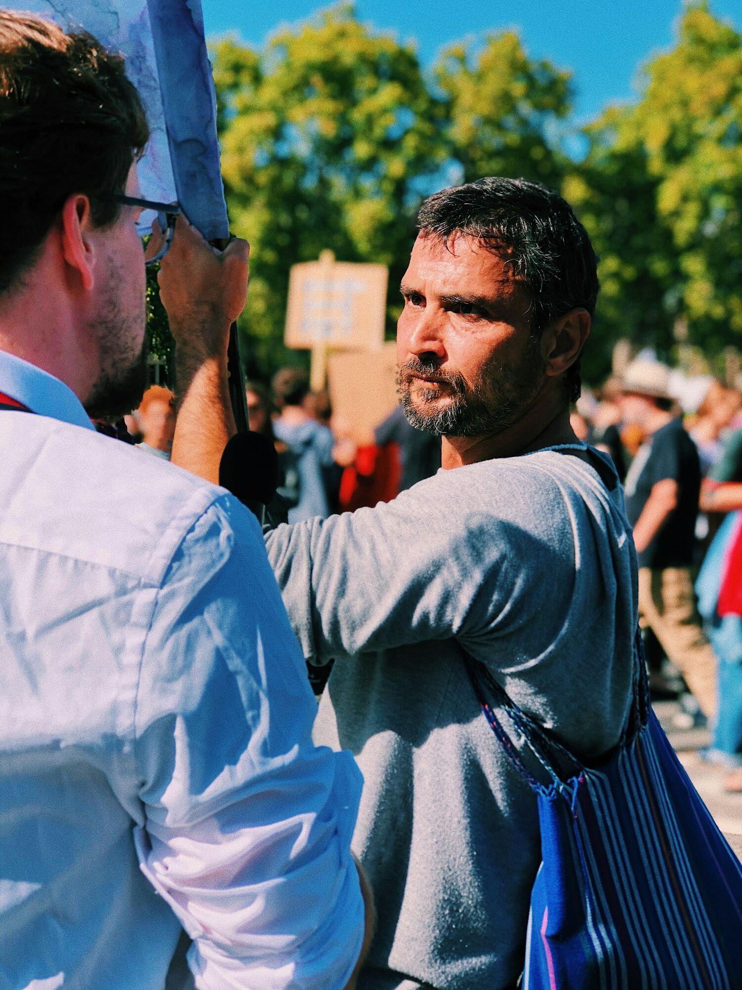 Demonstrator holding a sign among a crowd