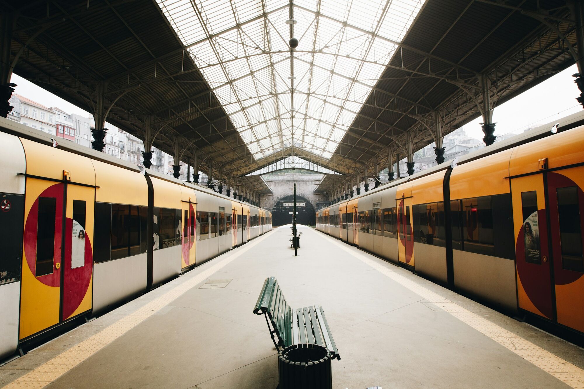 Two trains beside a covered station platform