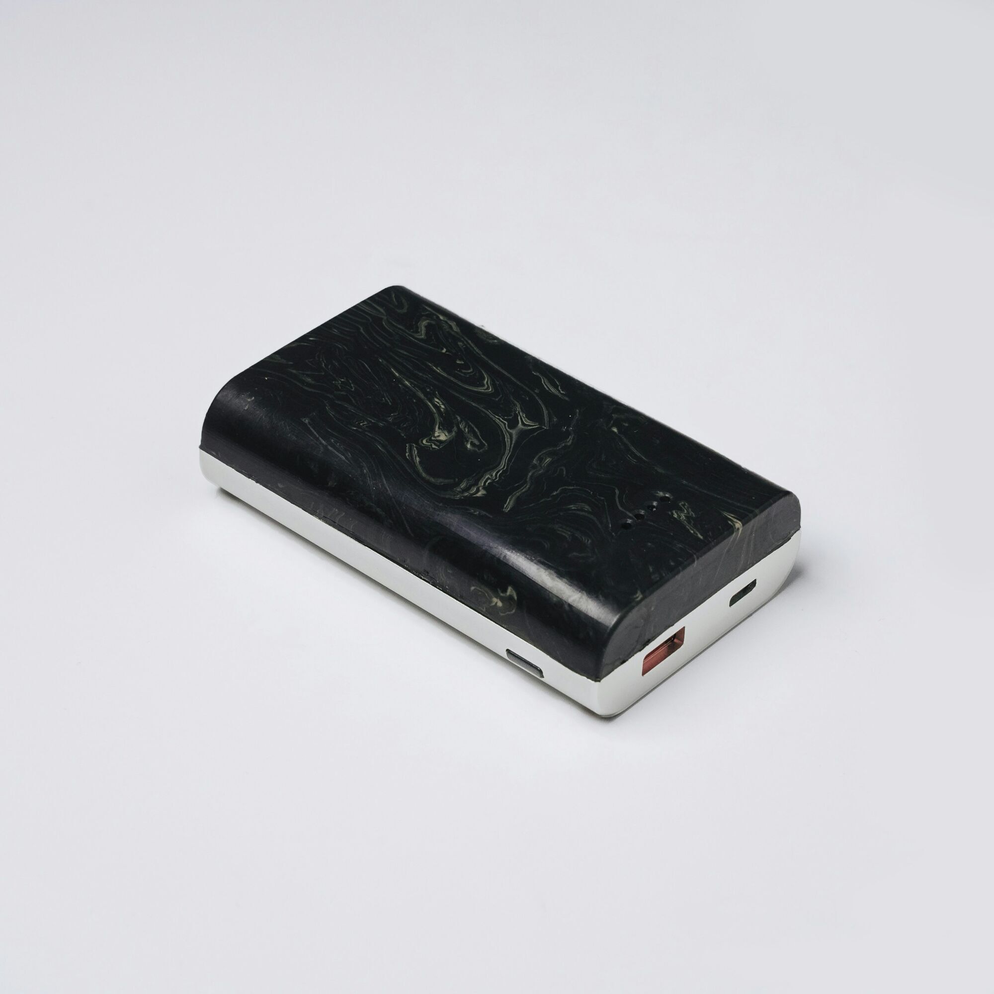Black portable power bank on white surface