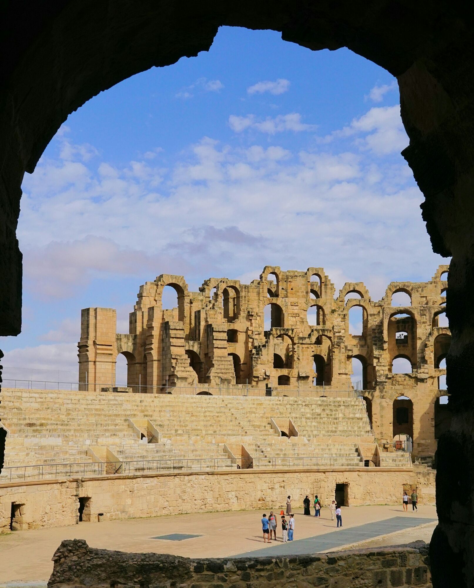 Visitors exploring the Roman amphitheatre of El Jem in Tunisia