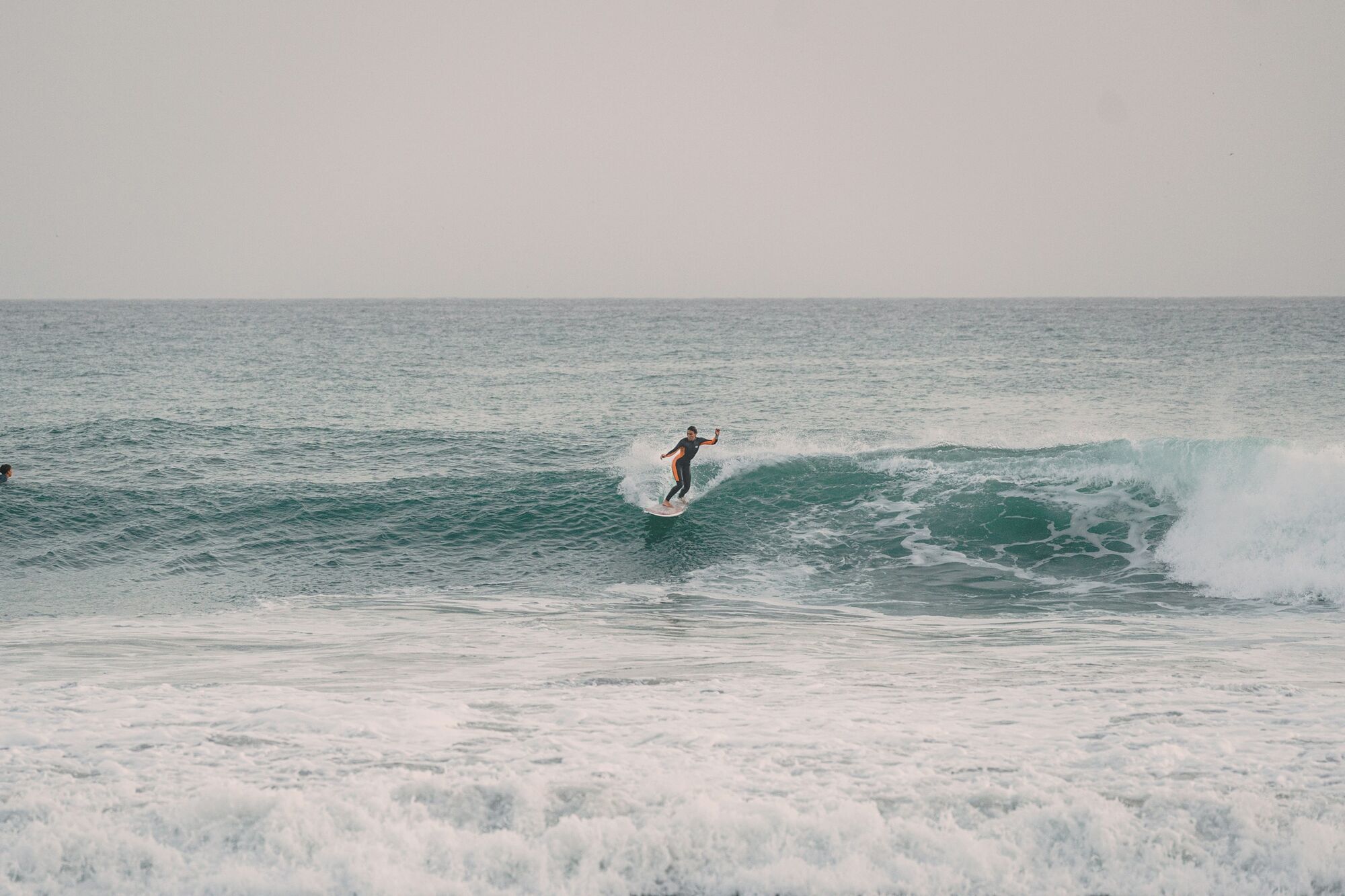 Surfer riding an ocean wave near the shore