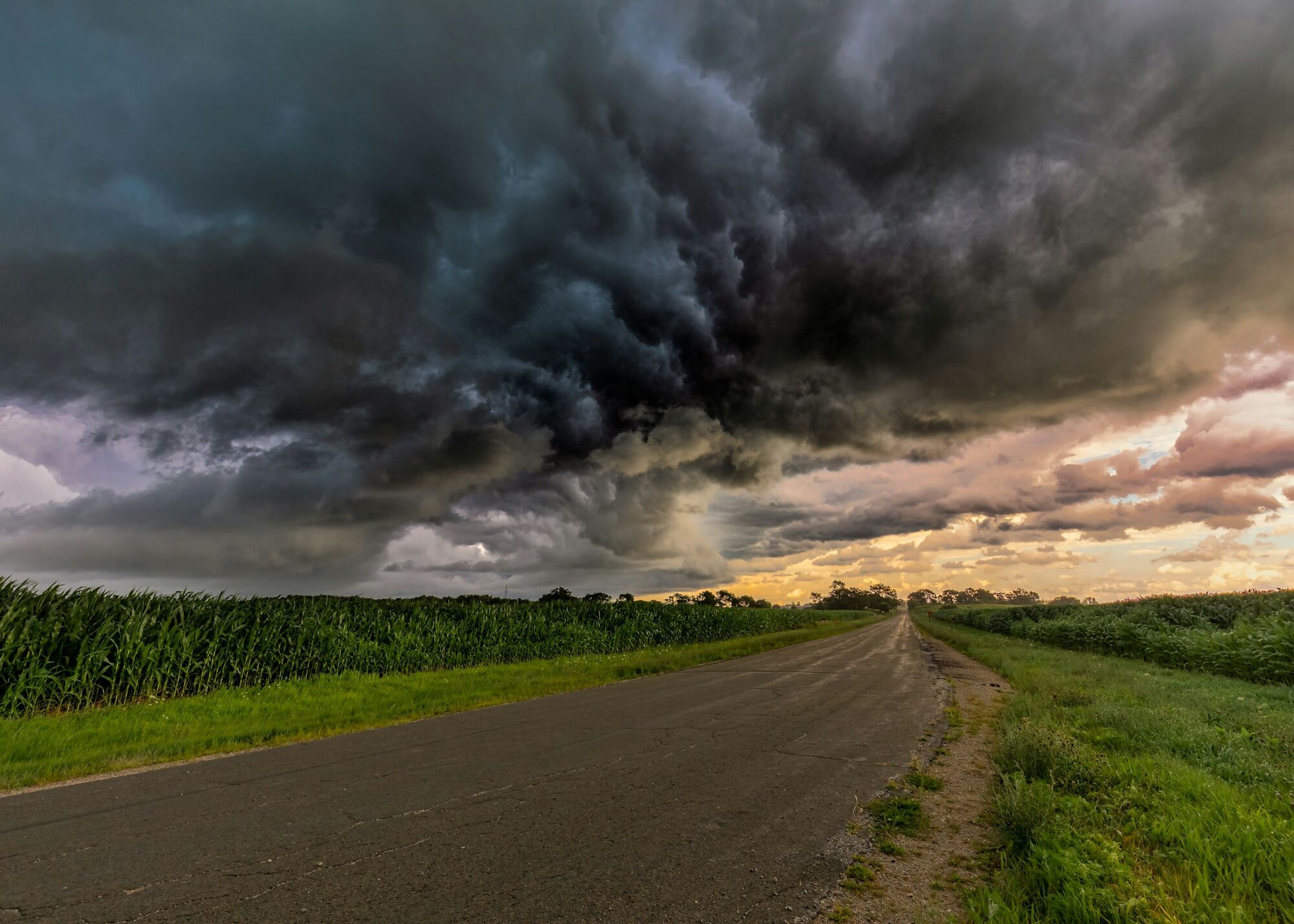 Dark storm clouds gathering over a rural road