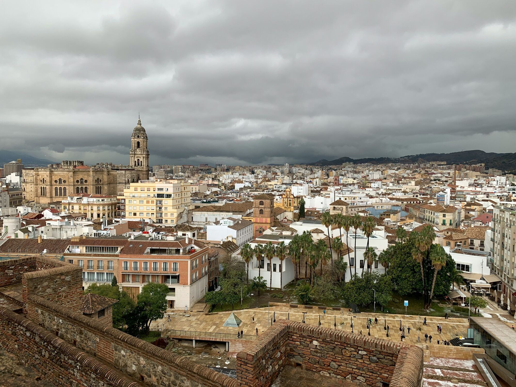 Málaga Cathedral and city rooftops beneath cloudy skies