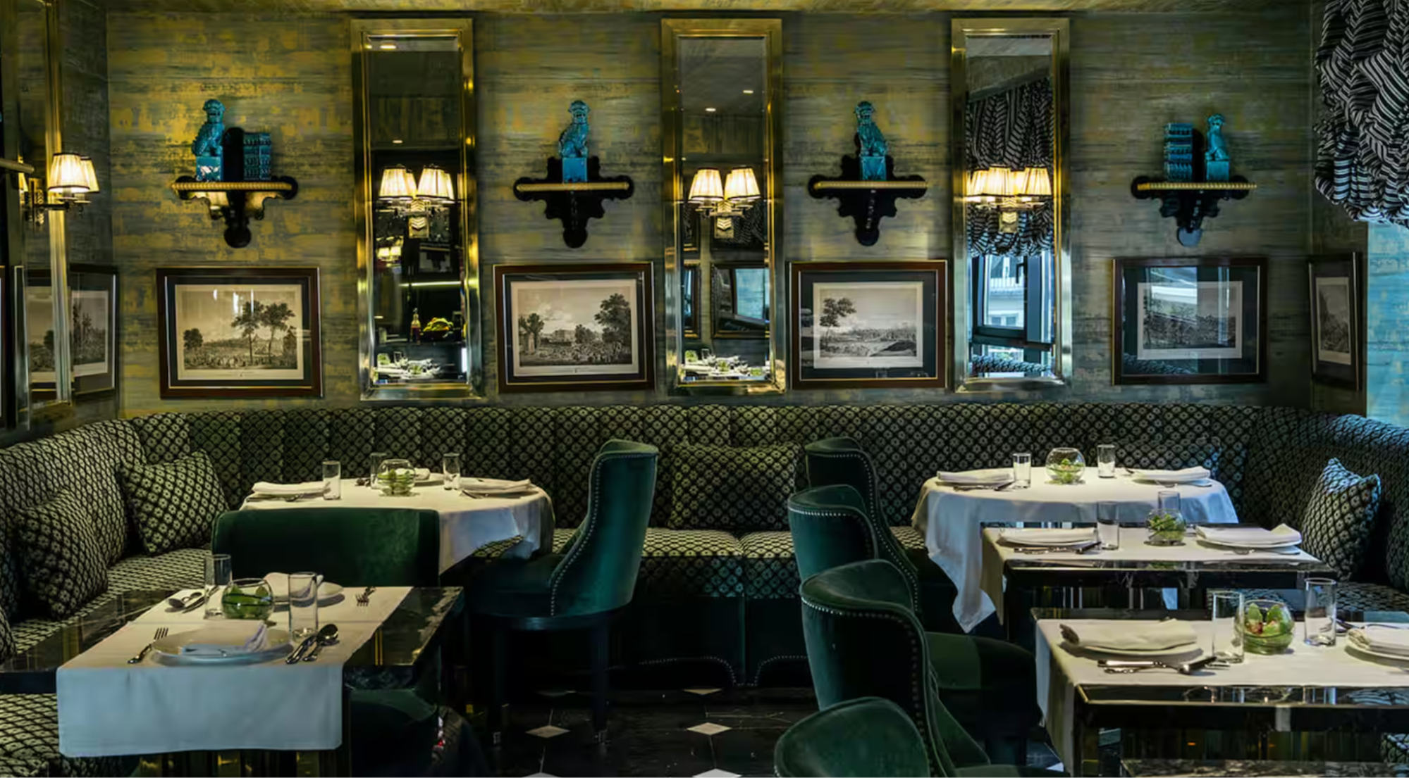 Elegant dining room with green velvet seating at Casa Verbena Madrid