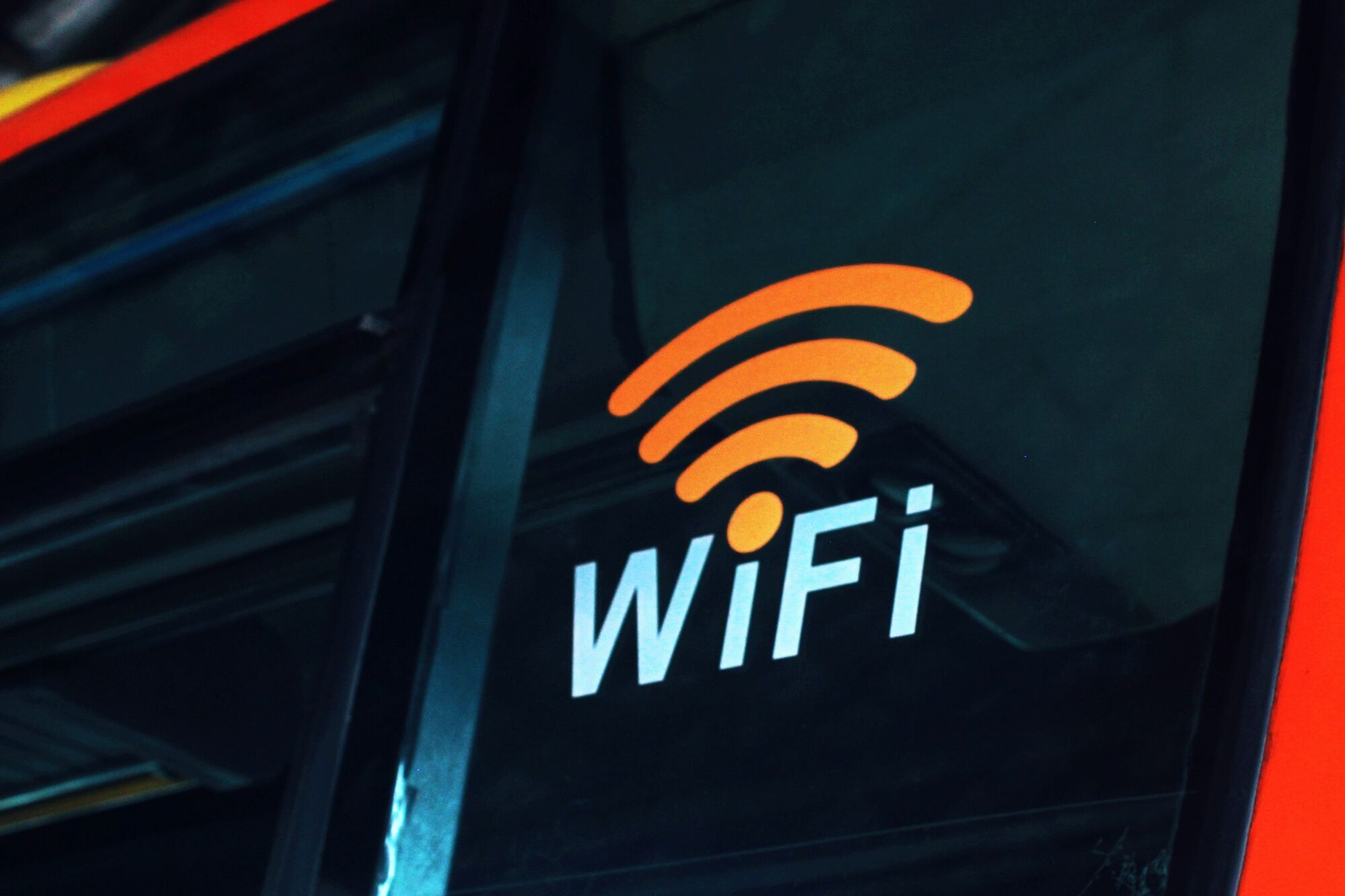 Illuminated Wi-Fi sign on a dark wall