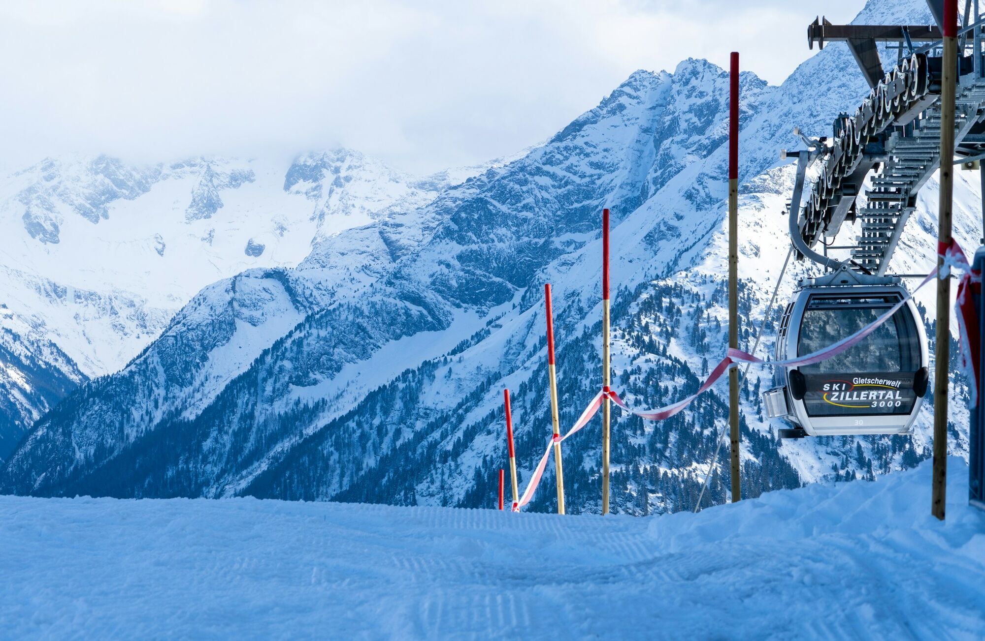 Ski Zillertal 3000 gondola lift surrounded by snow-covered mountains