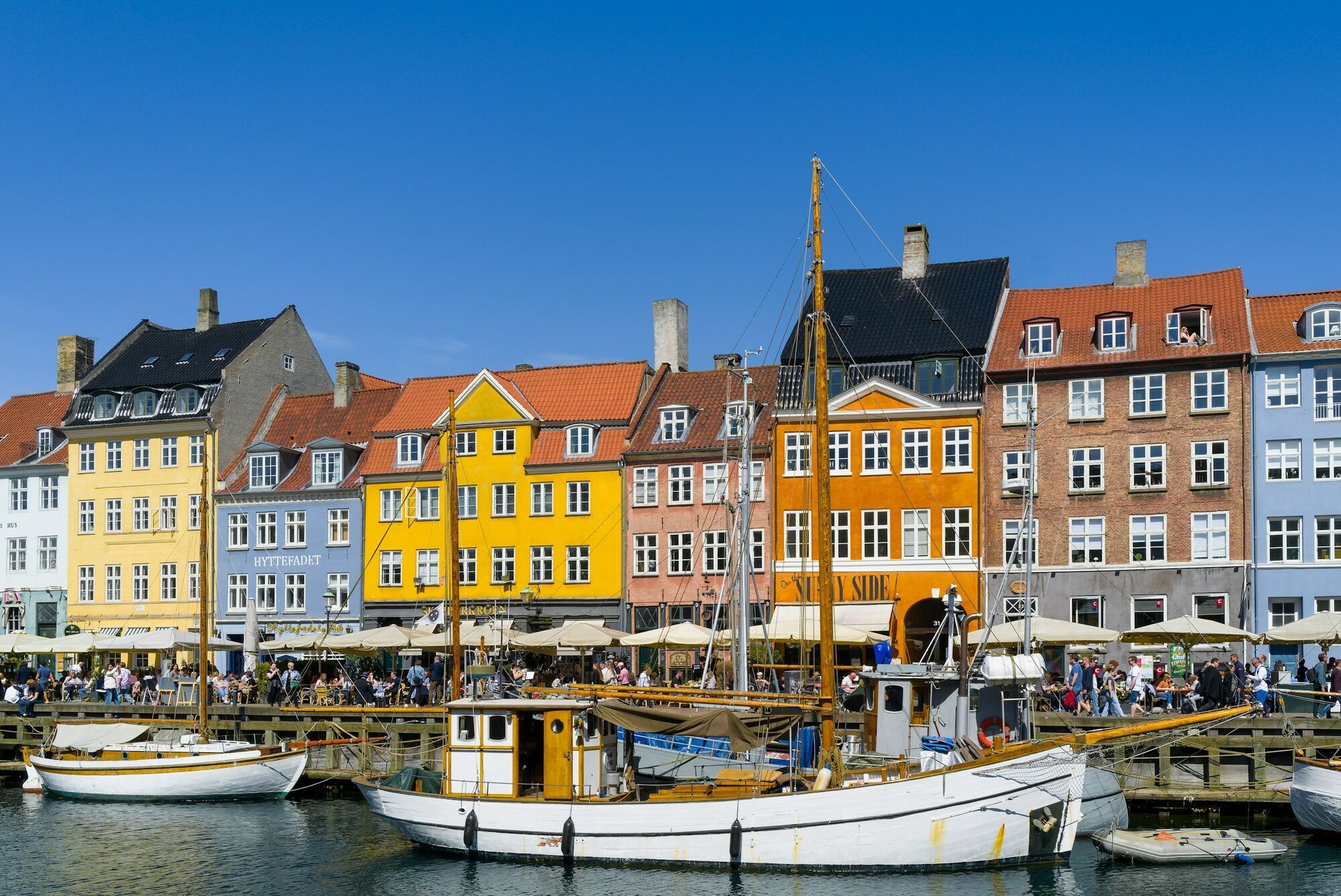 Colourful waterfront buildings and boats along Nyhavn harbour in Copenhagen