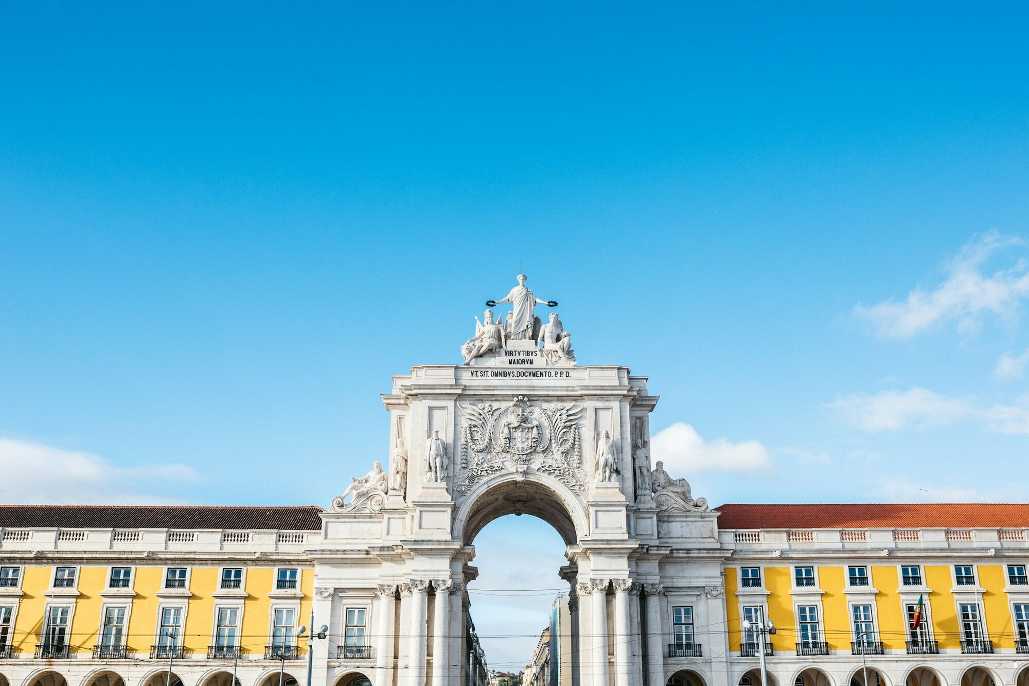 Rua Augusta Arch at Praça do Comércio in Lisbon, framed by yellow historic buildings