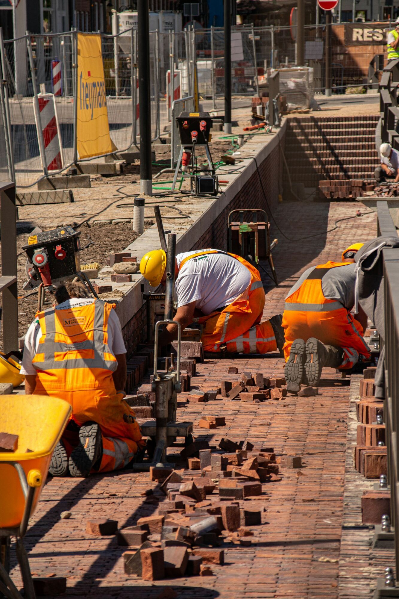 Construction workers laying bricks at an outdoor worksite