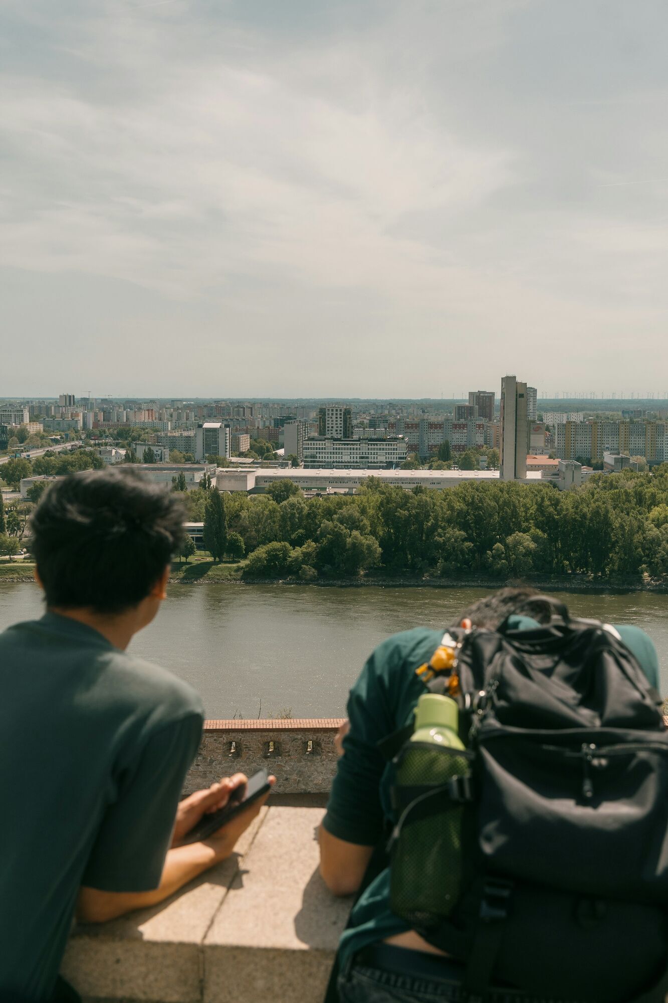 Two travellers overlooking the river and city skyline in Bratislava