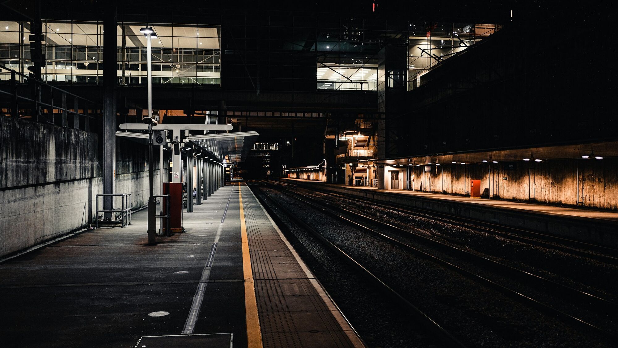 Empty railway station platforms illuminated at night