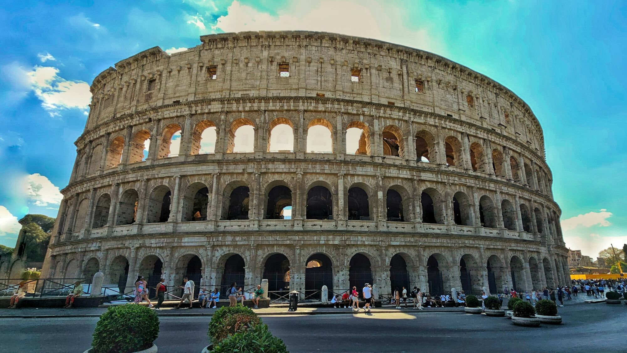 Tourists walking outside the Colosseum in Rome