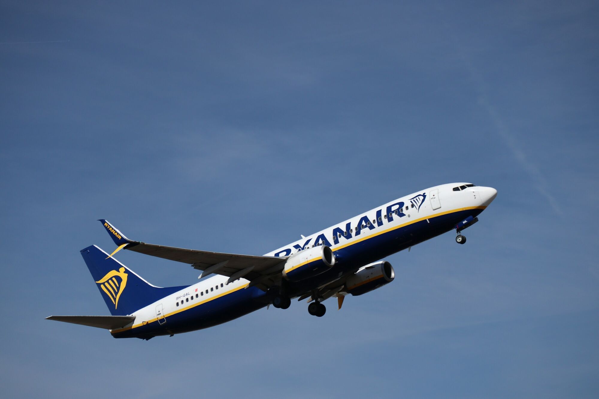 Ryanair aircraft taking off against a blue sky