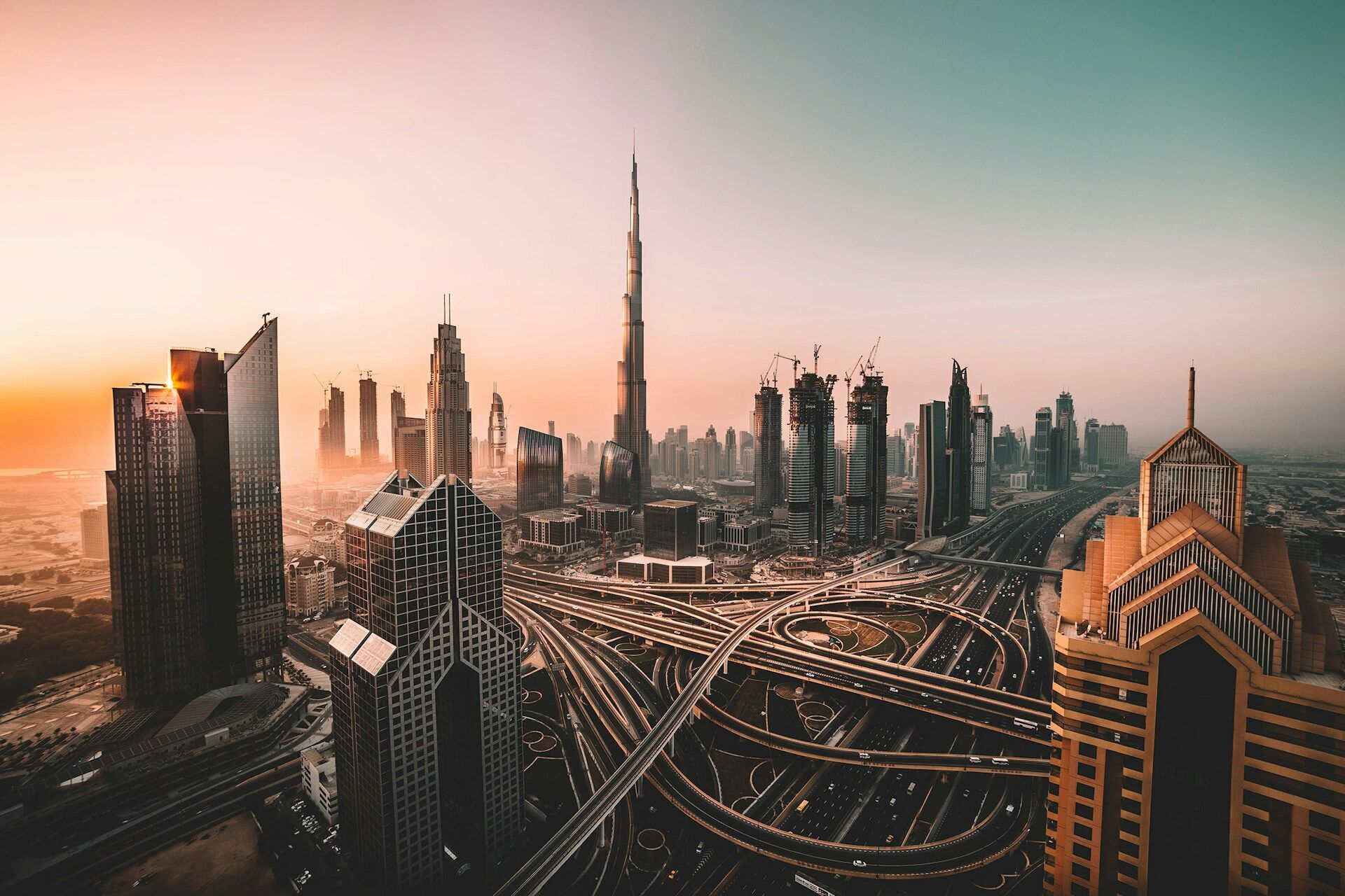 Dubai skyline at sunset with Burj Khalifa and surrounding skyscrapers