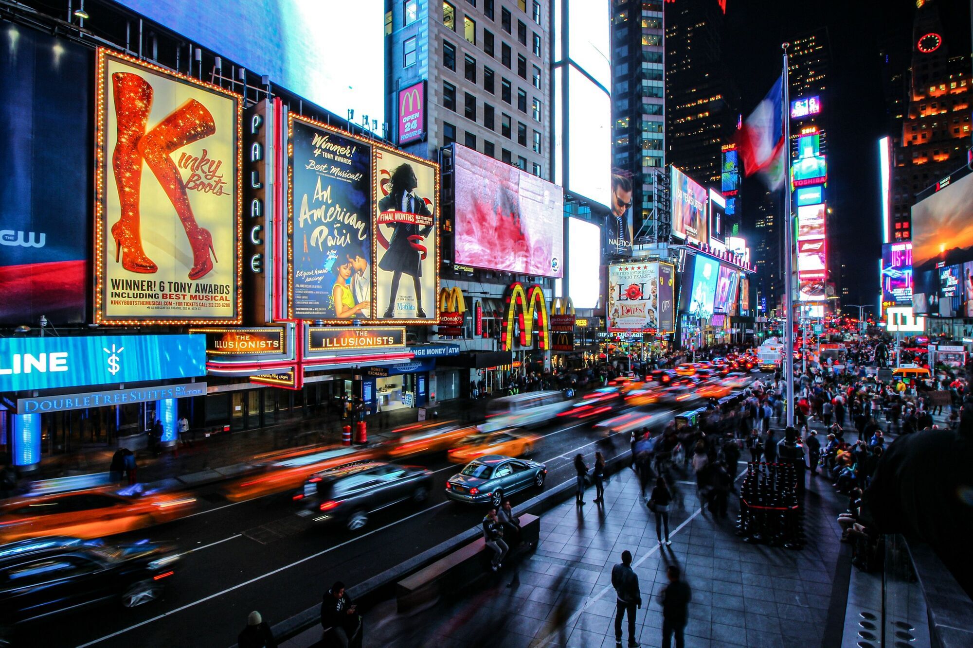 Illuminated Broadway billboards and busy traffic in Times Square at night