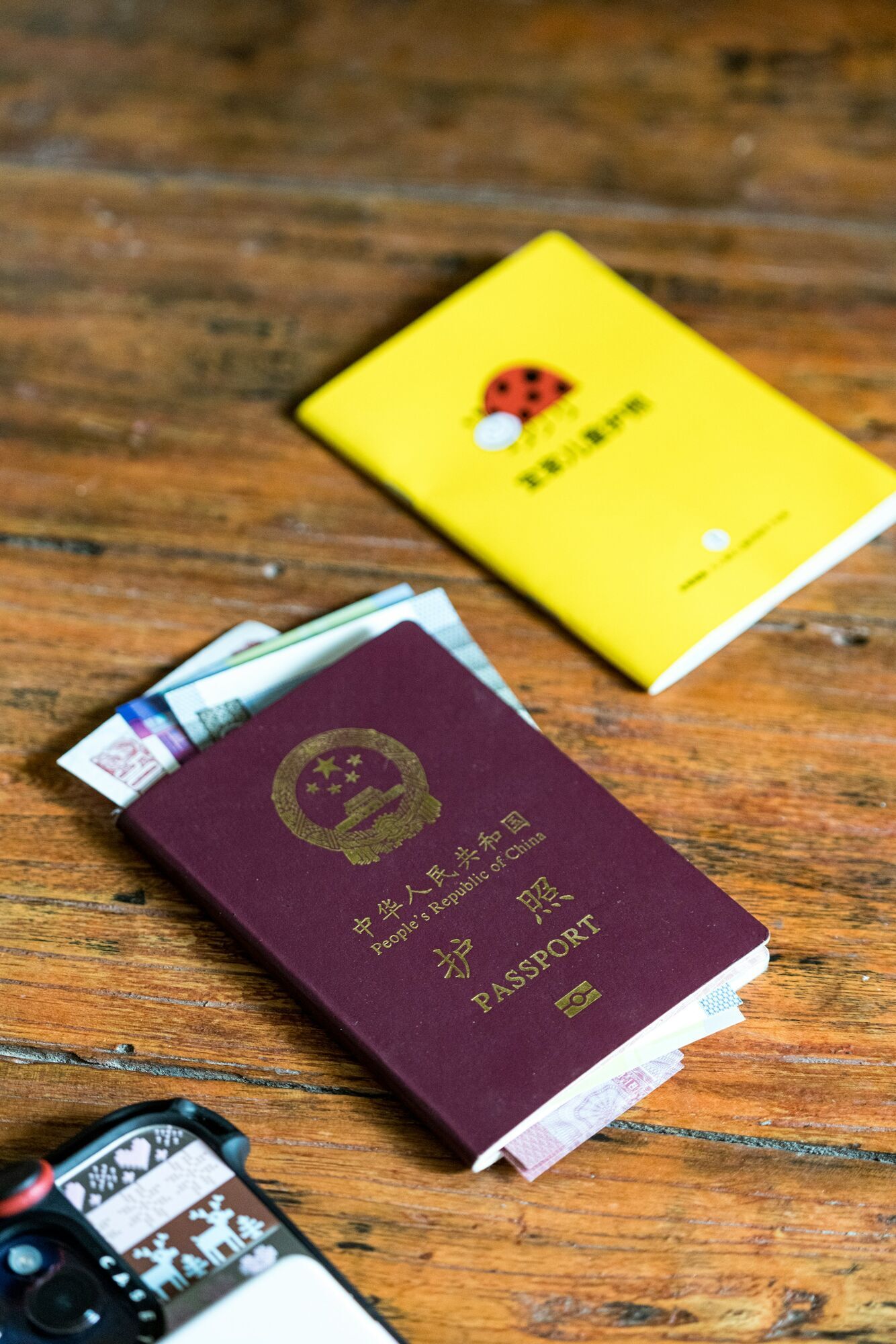 Chinese passport and travel documents on a wooden table
