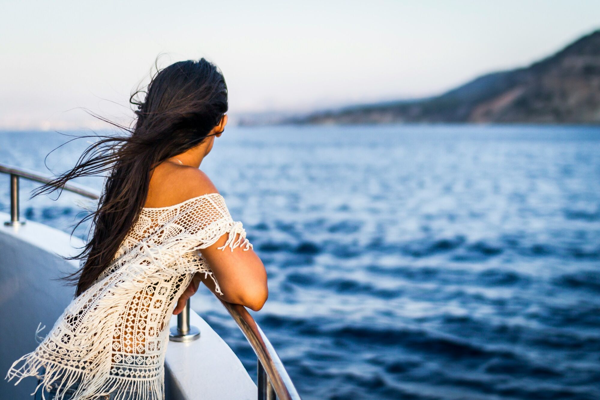 Woman looking out over the sea from a cruise ship