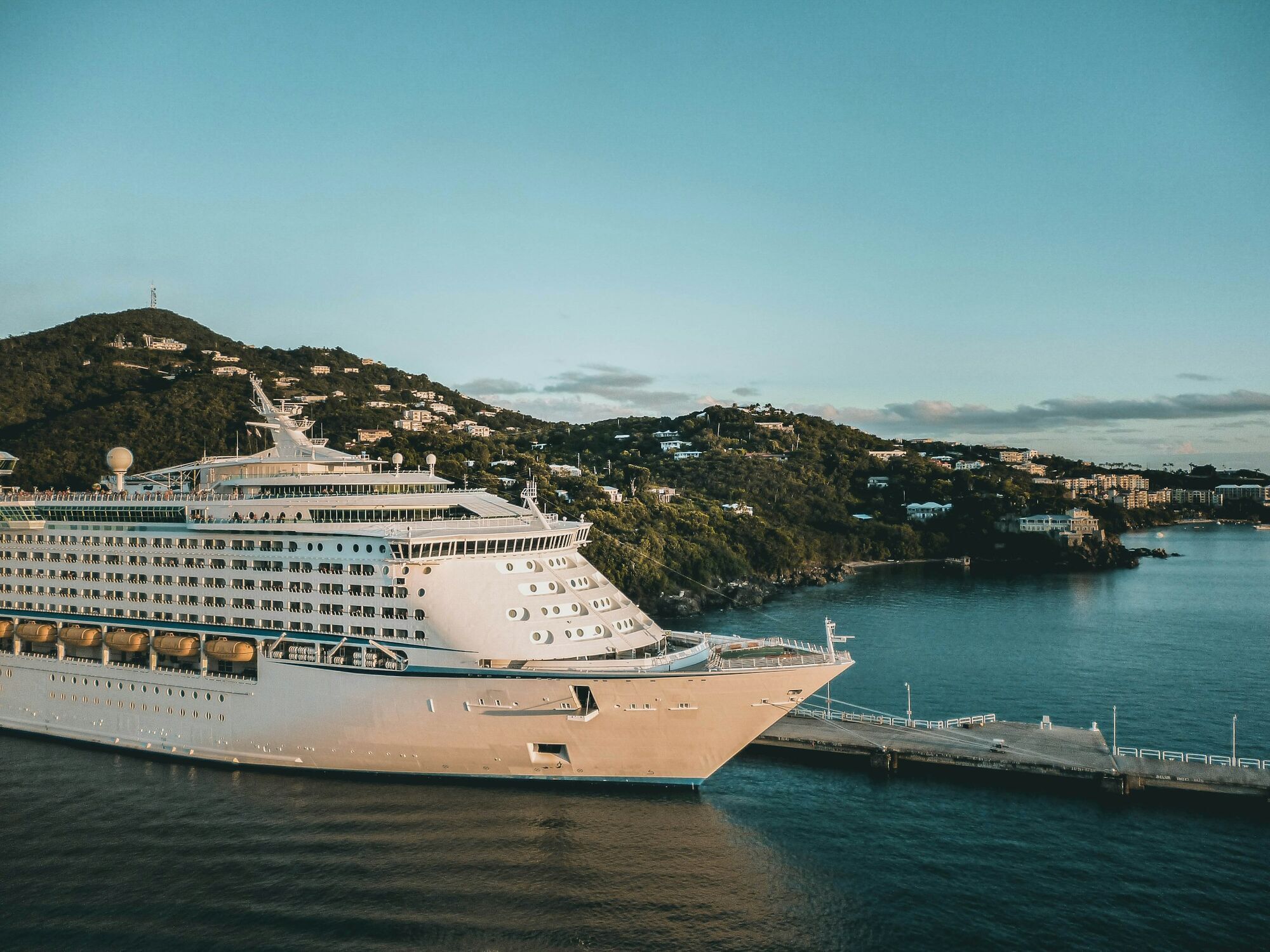 Cruise ship docked beside a coastal town