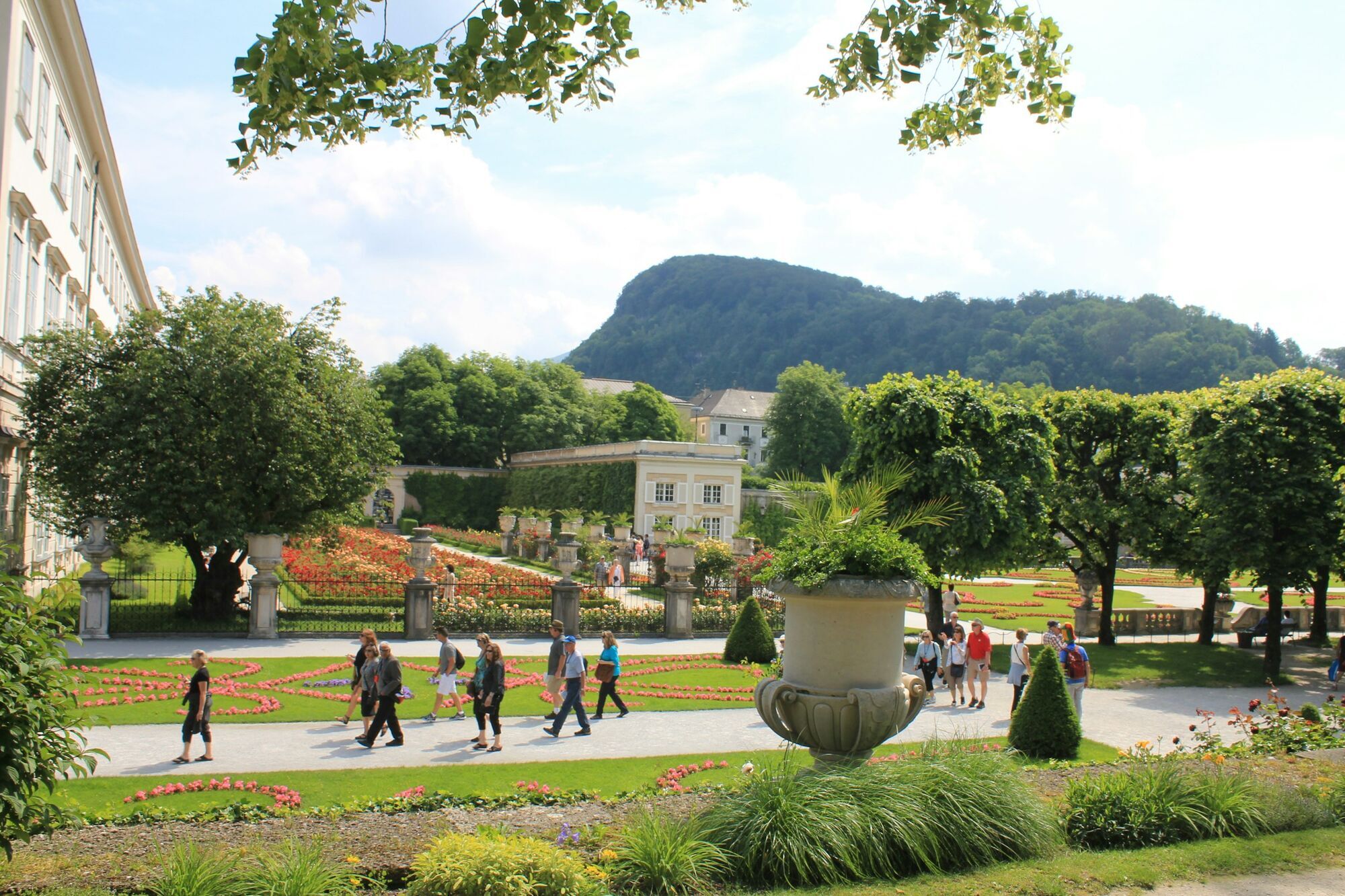 Visitors walking through Mirabell Gardens in Salzburg