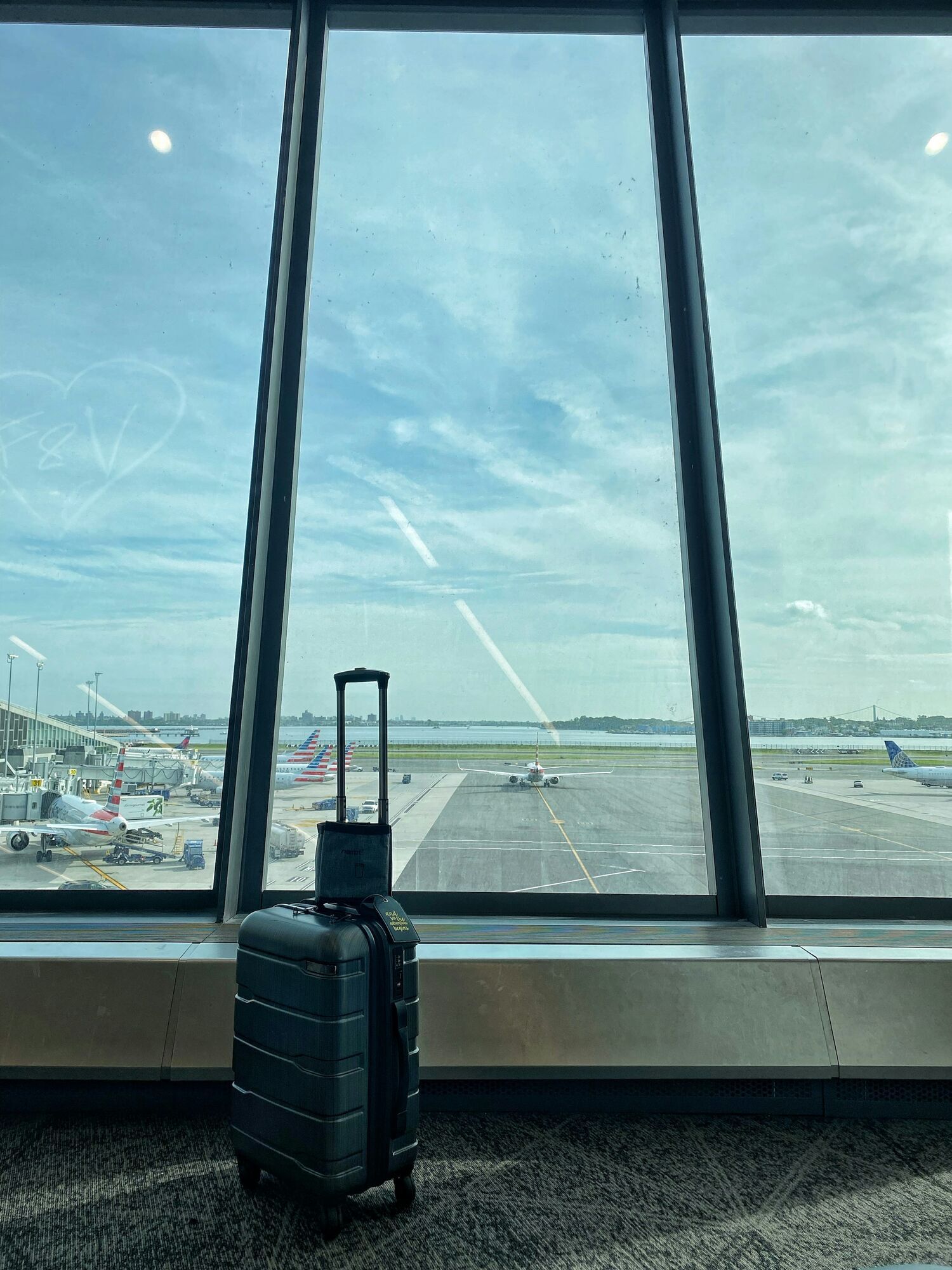 Cabin suitcase beside an airport window