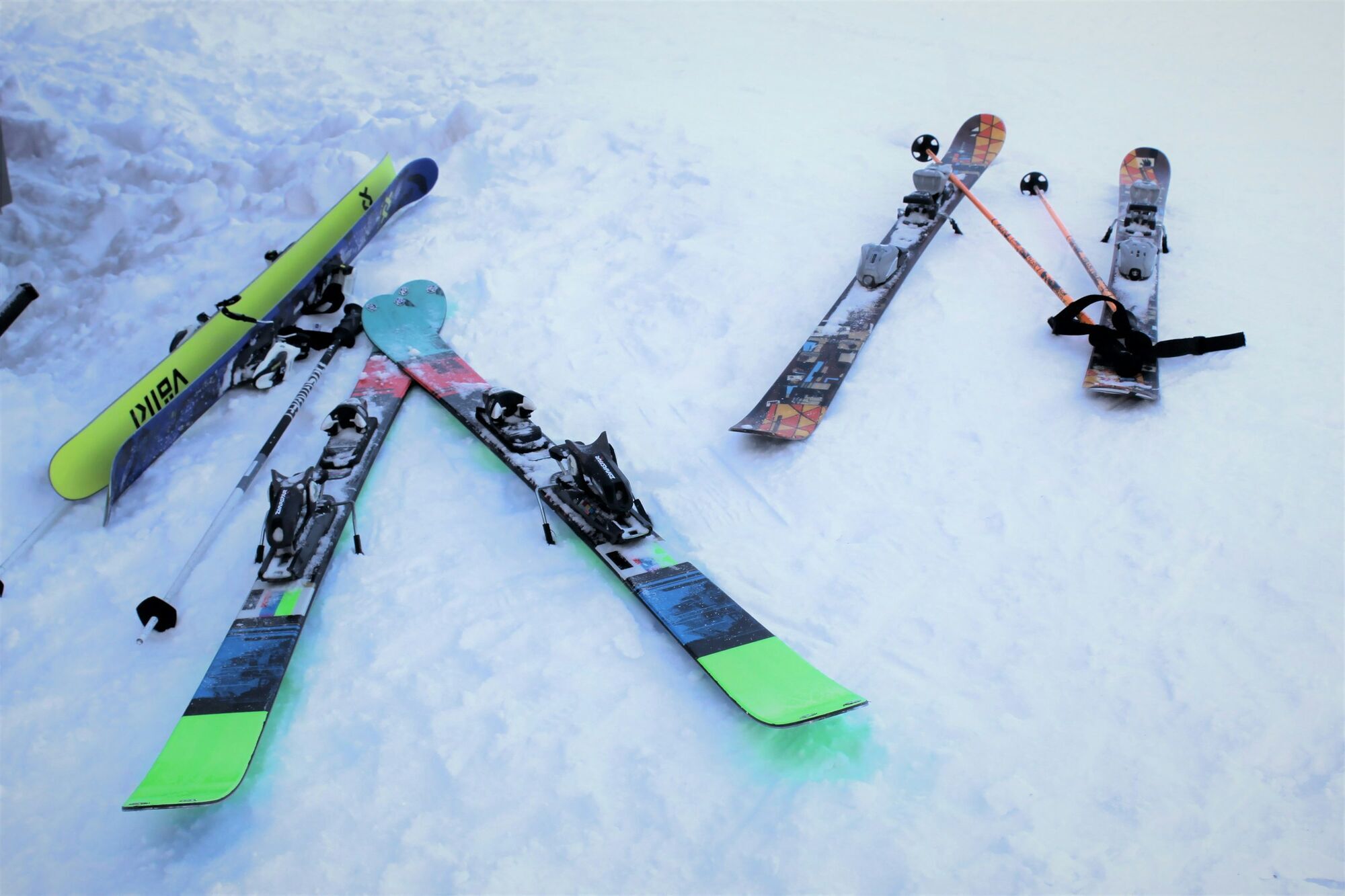 Ski equipment laid out on snow before winter trip
