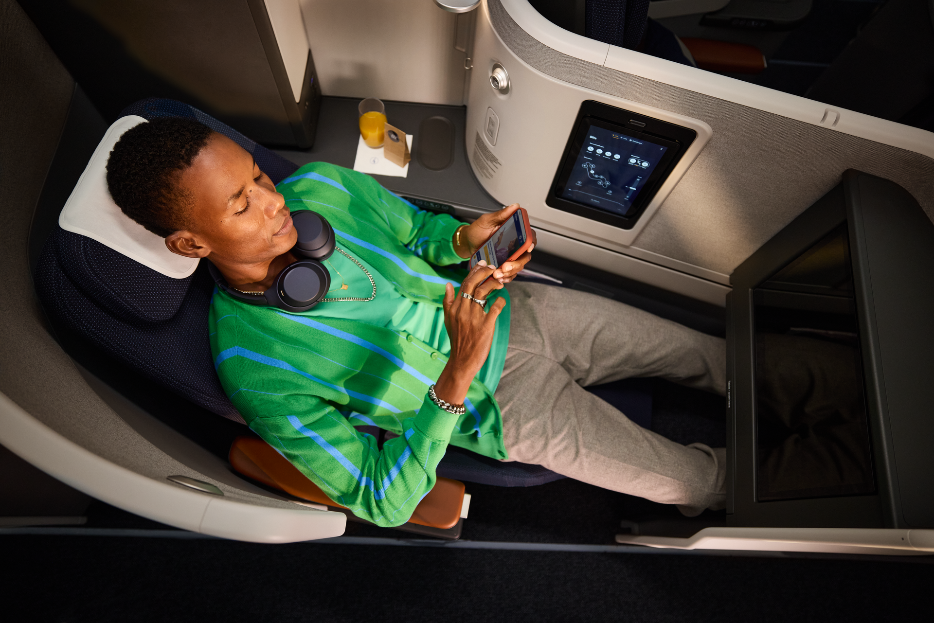 Passenger relaxing in Lufthansa Allegris Business Class seat on Boeing 787-9