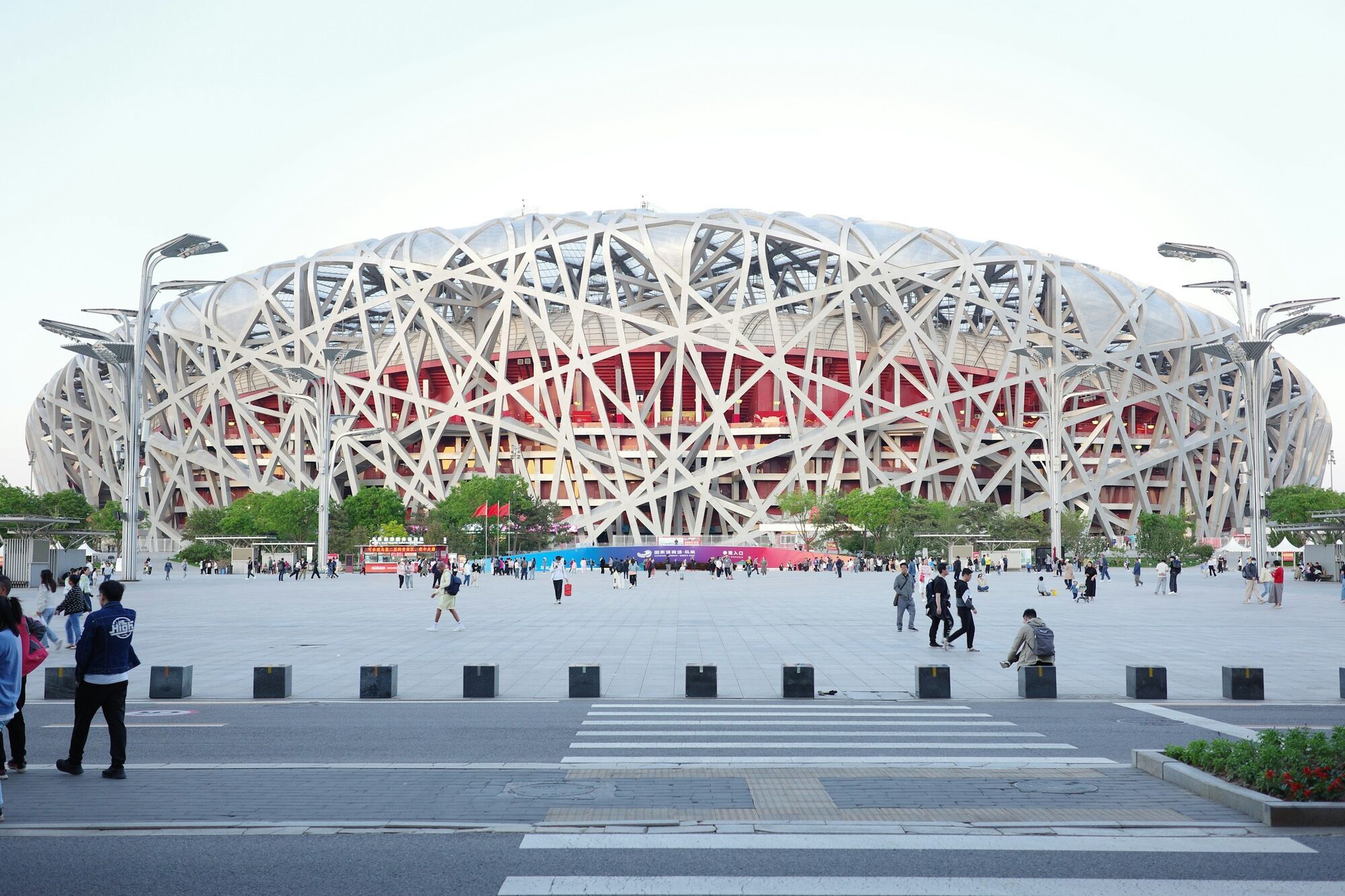 Beijing National Stadium exterior with visitors in the plaza
