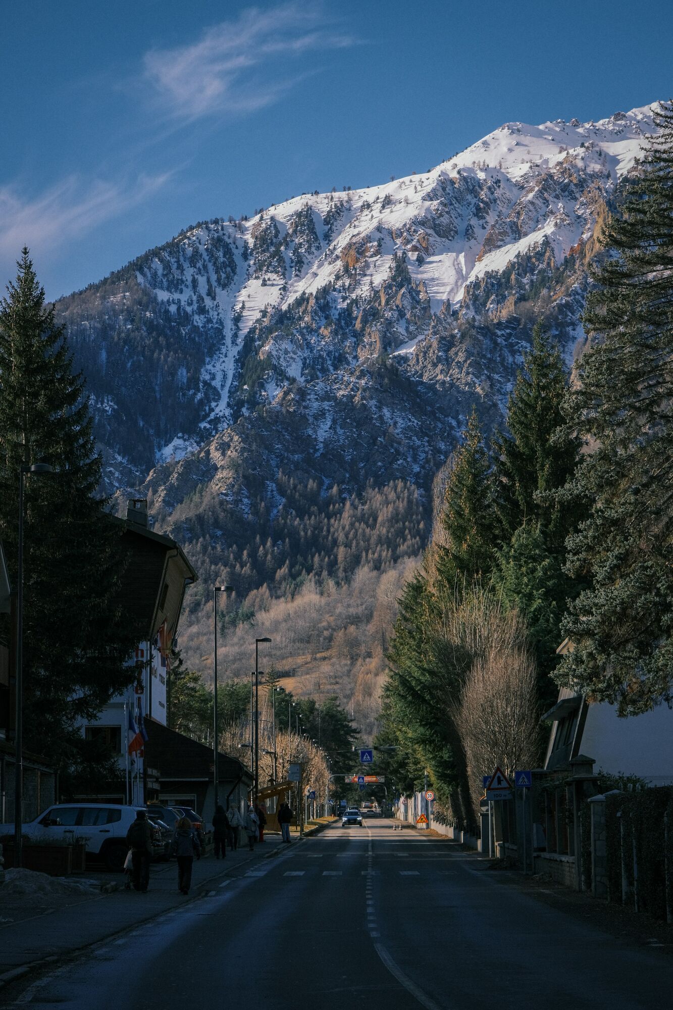 Snow-covered Alpine mountains above a small Italian town near Turin