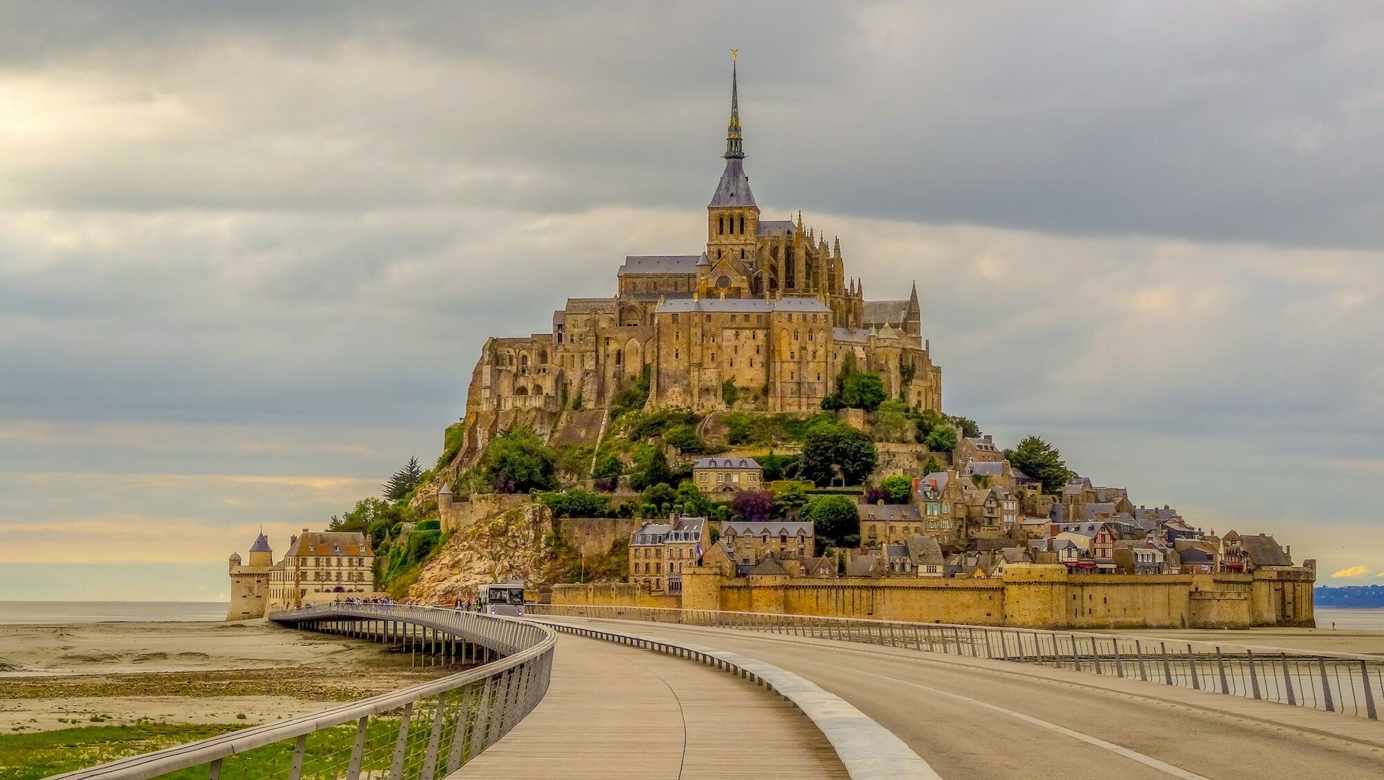 Mont Saint-Michel abbey connected by causeway at low tide
