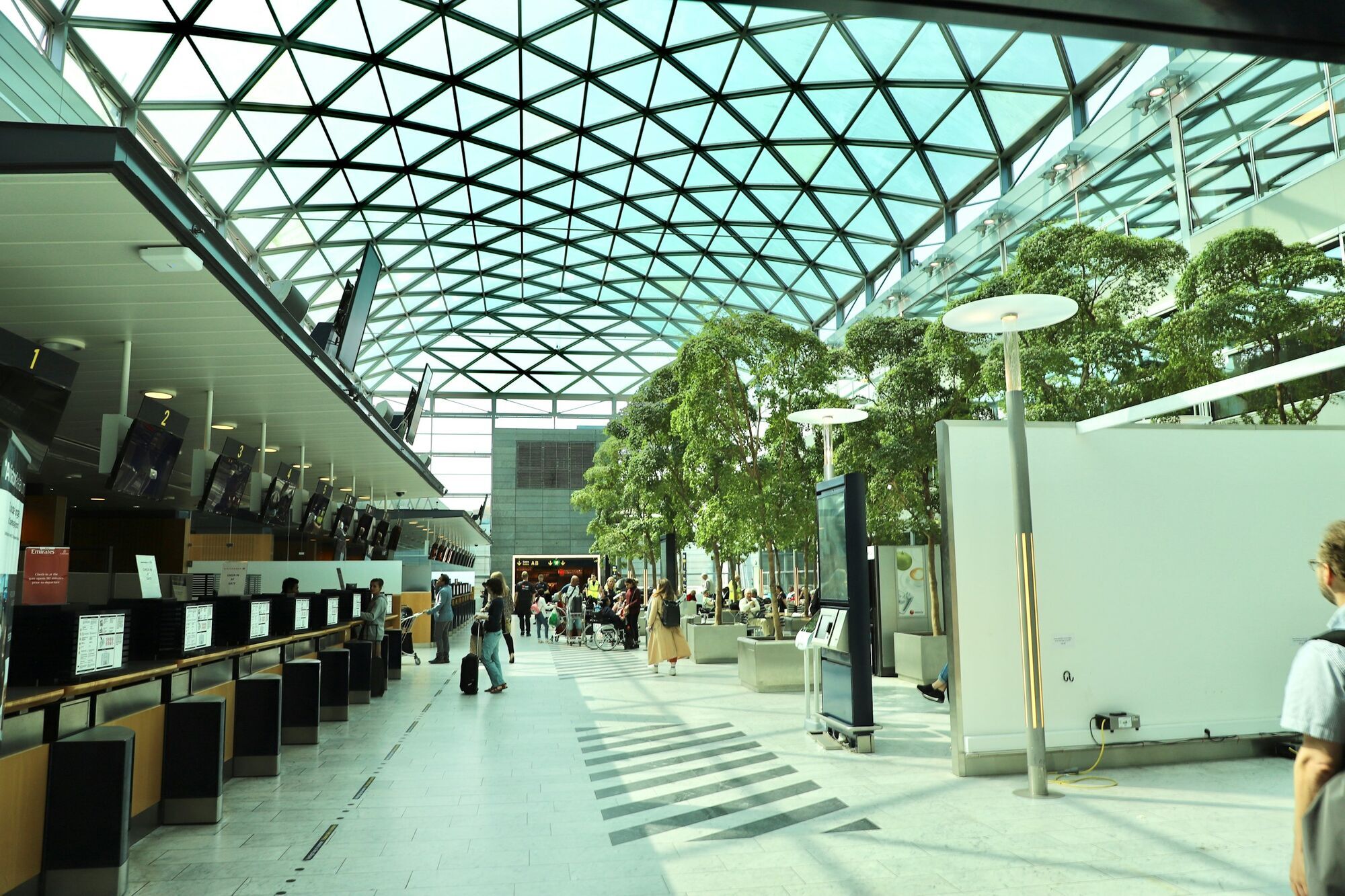 Modern European airport terminal with natural light and passenger seating area